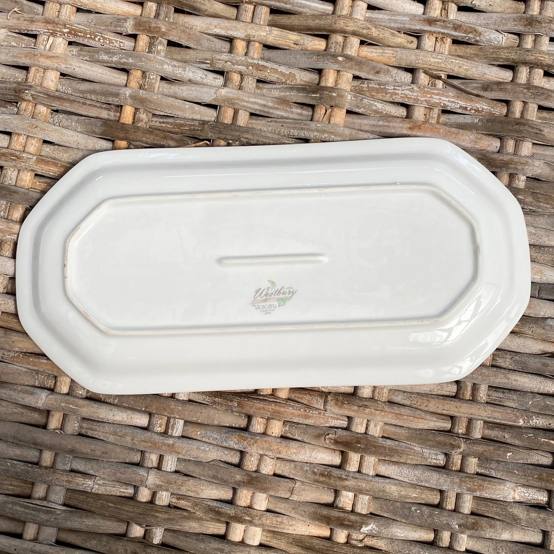 Underside of the platter showing the full base shape and footed rim