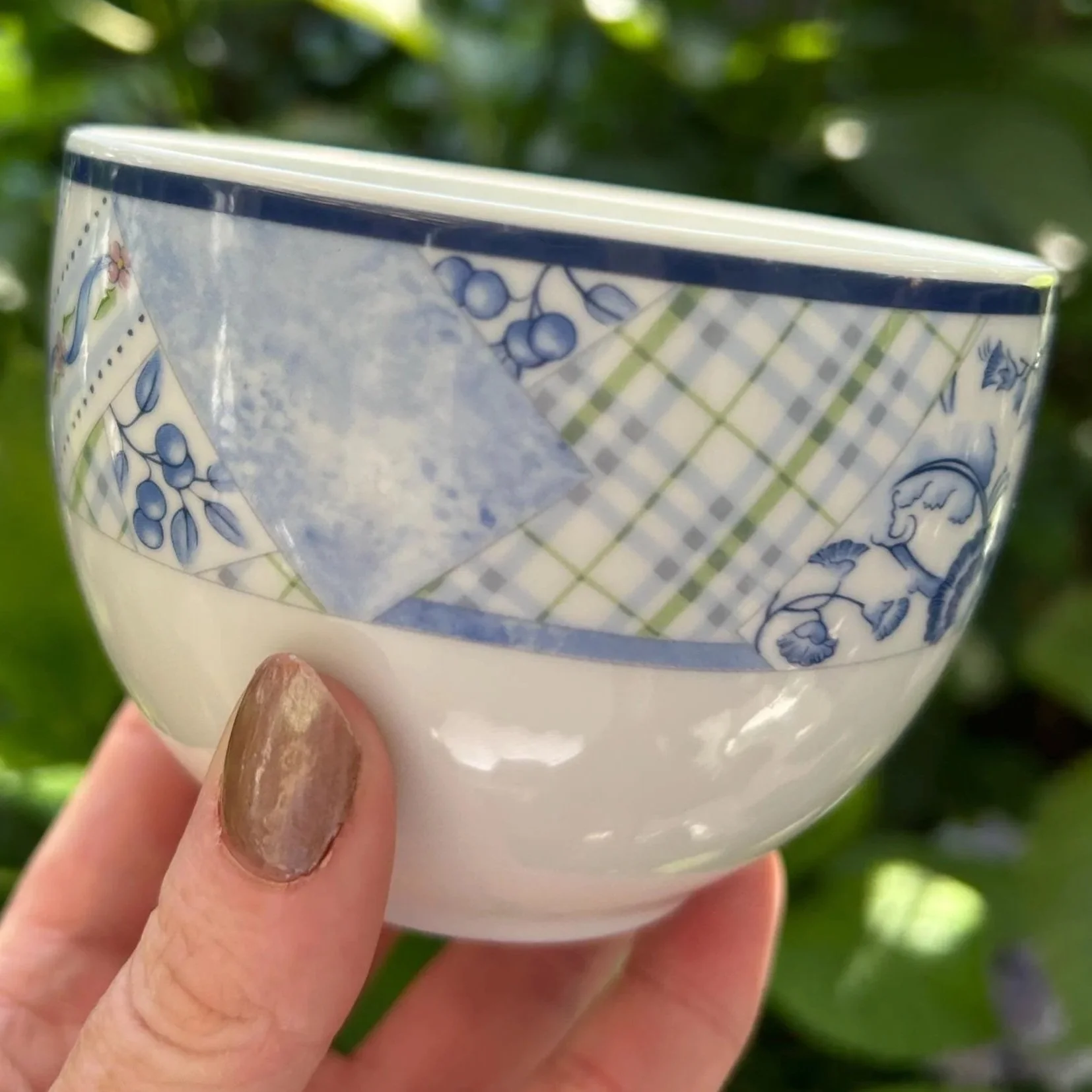 Close-up of one piece from the set showing the blue patchwork border with floral and check detail