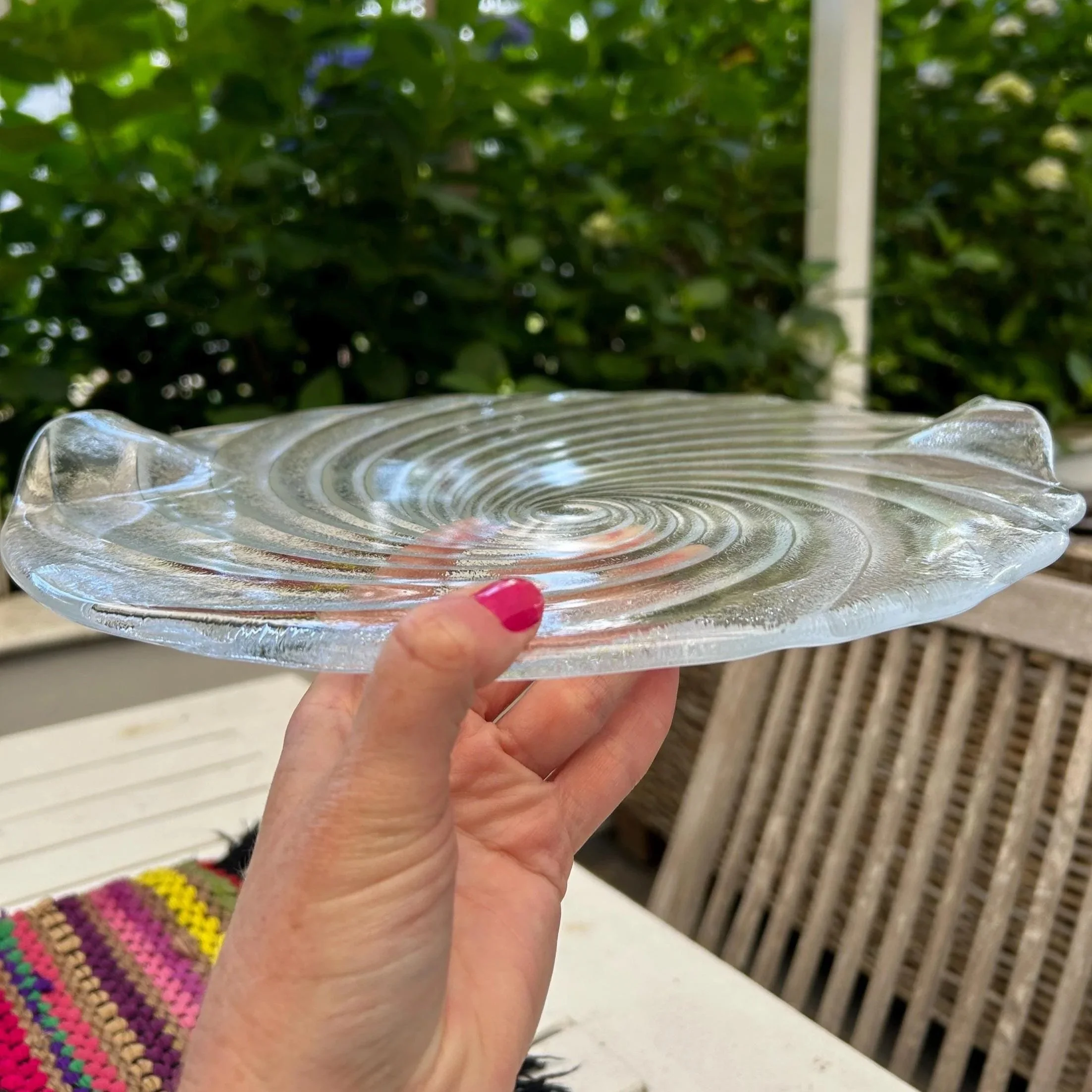 Platter held horizontally showing raised handles and shape.