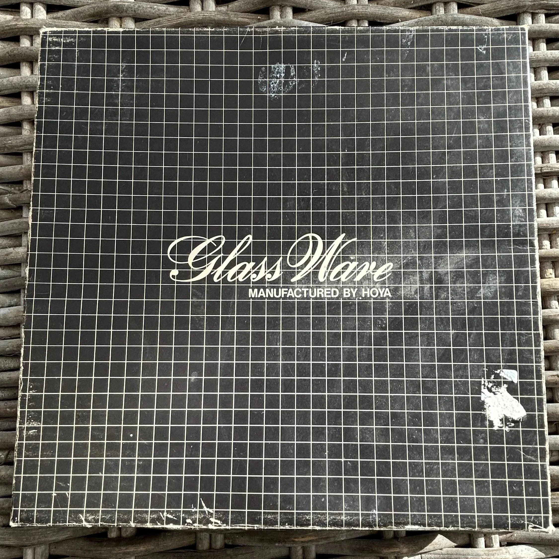 Original Hoya box with grid design and logo (visible wear)