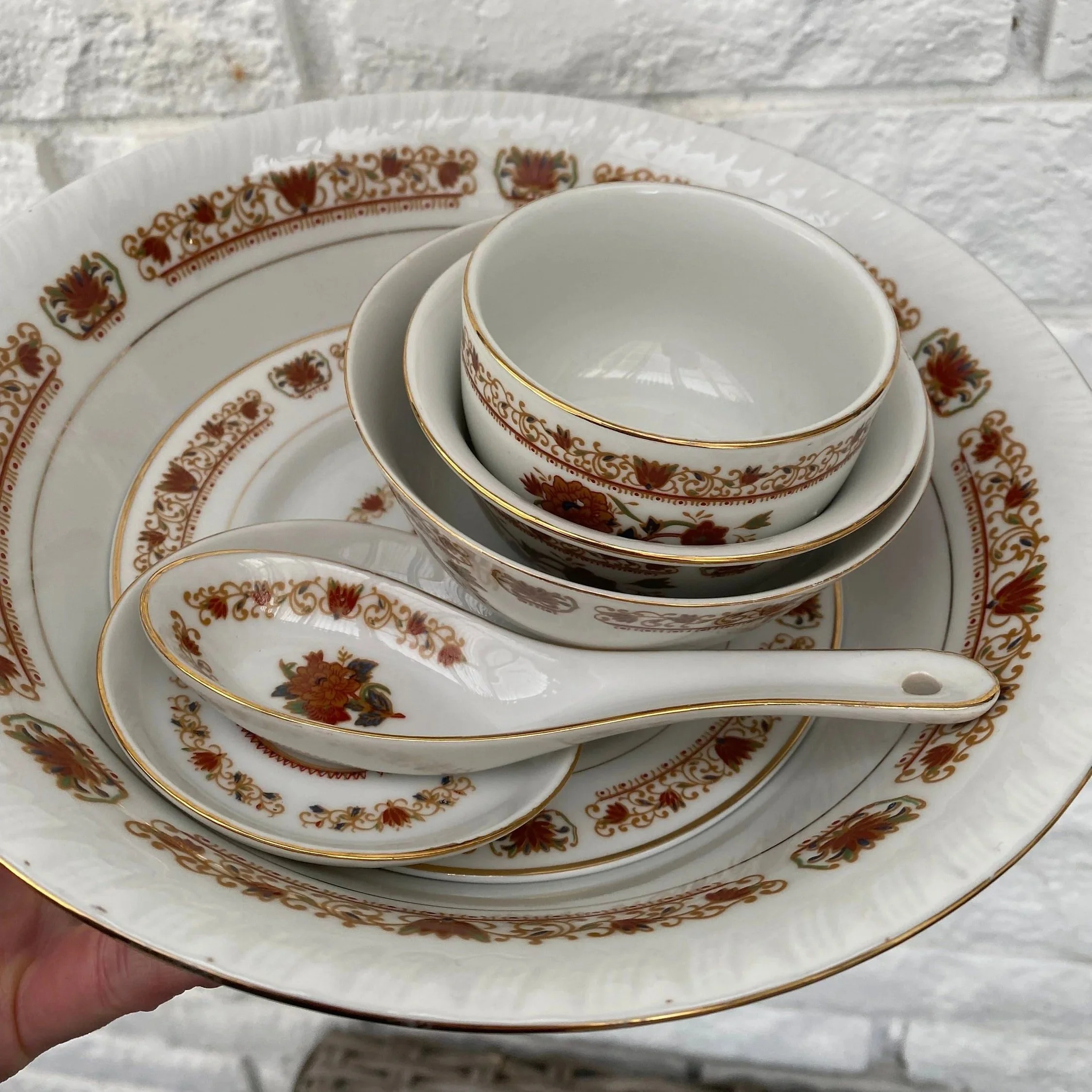Grouped close-up of plates, bowls, and spoons stacked together