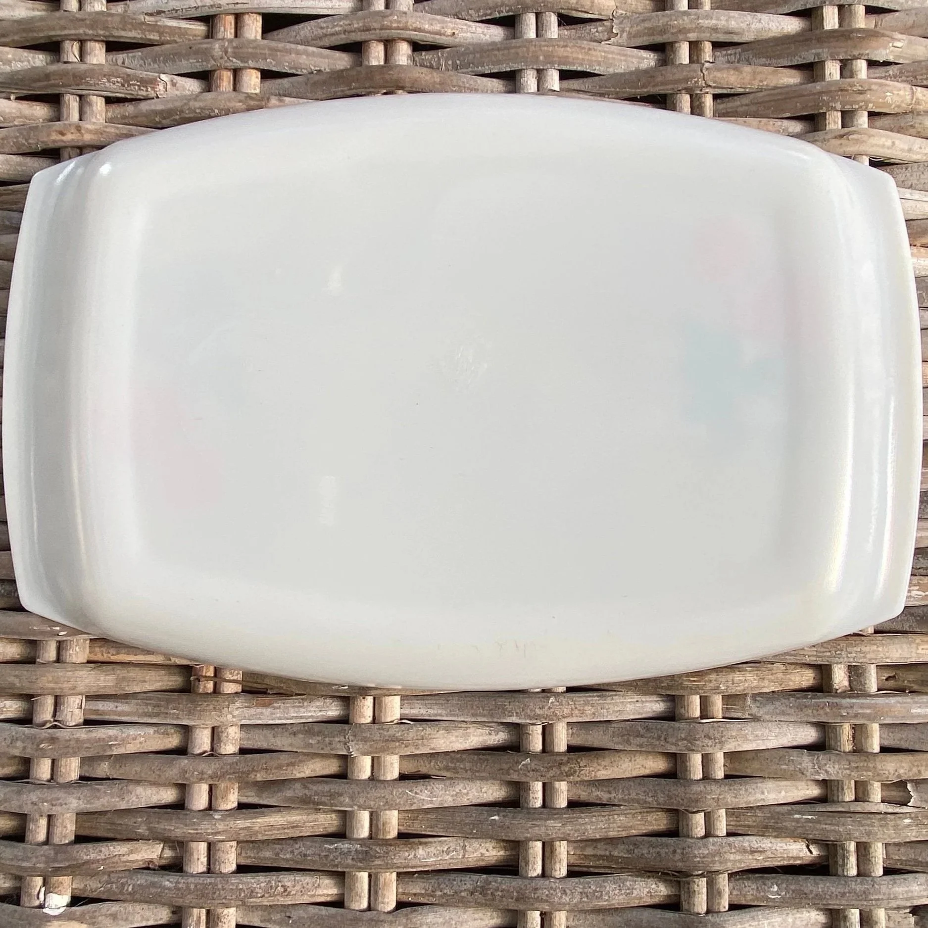 Underside of the tray showing smooth white milk glass base