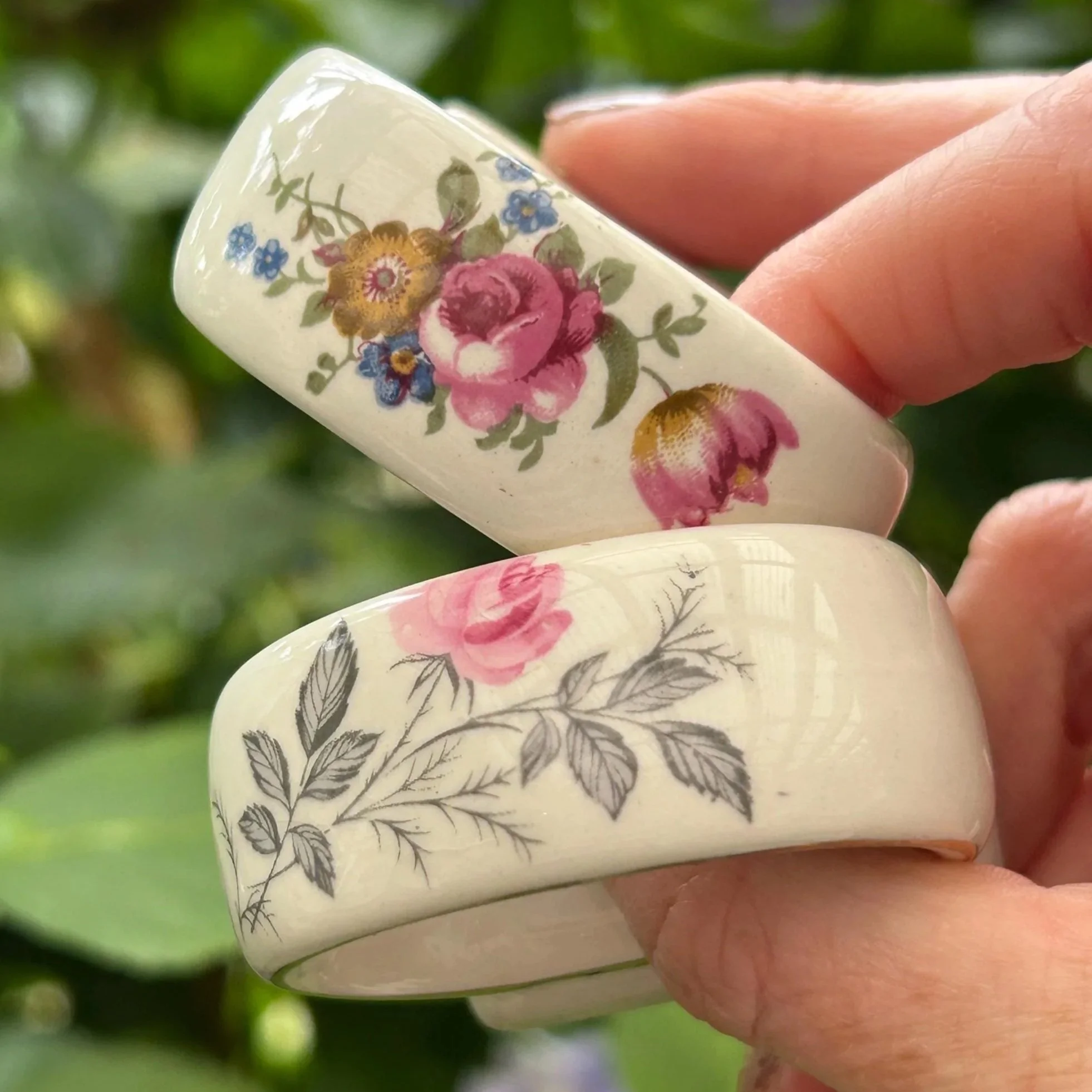 Mismatched Myott bone china napkin rings with floral prints, held in hand