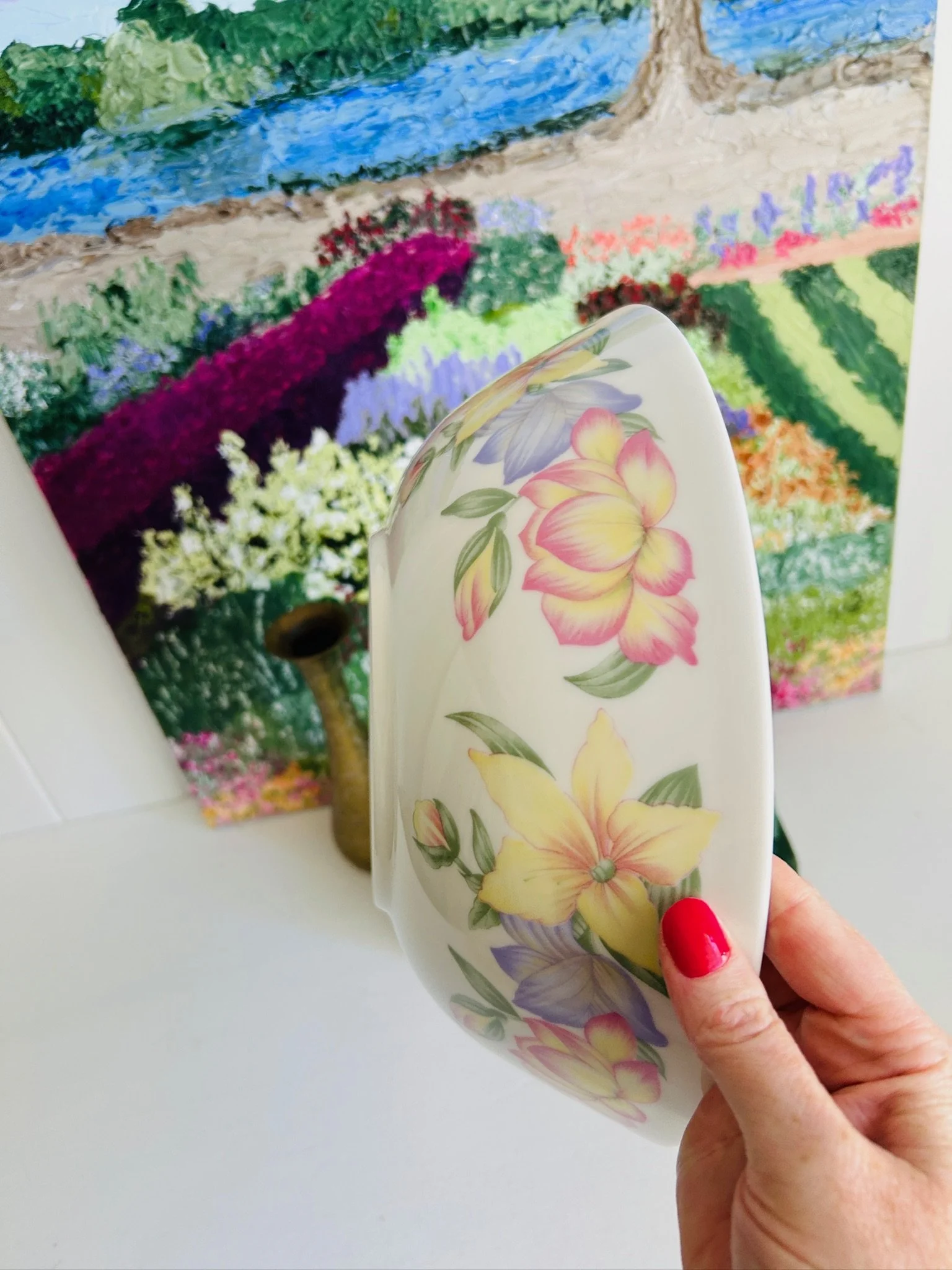 Side view of the vintage Royal Doulton serving bowl held in hand, highlighting the deep shape, floral pattern, and gently flared rim