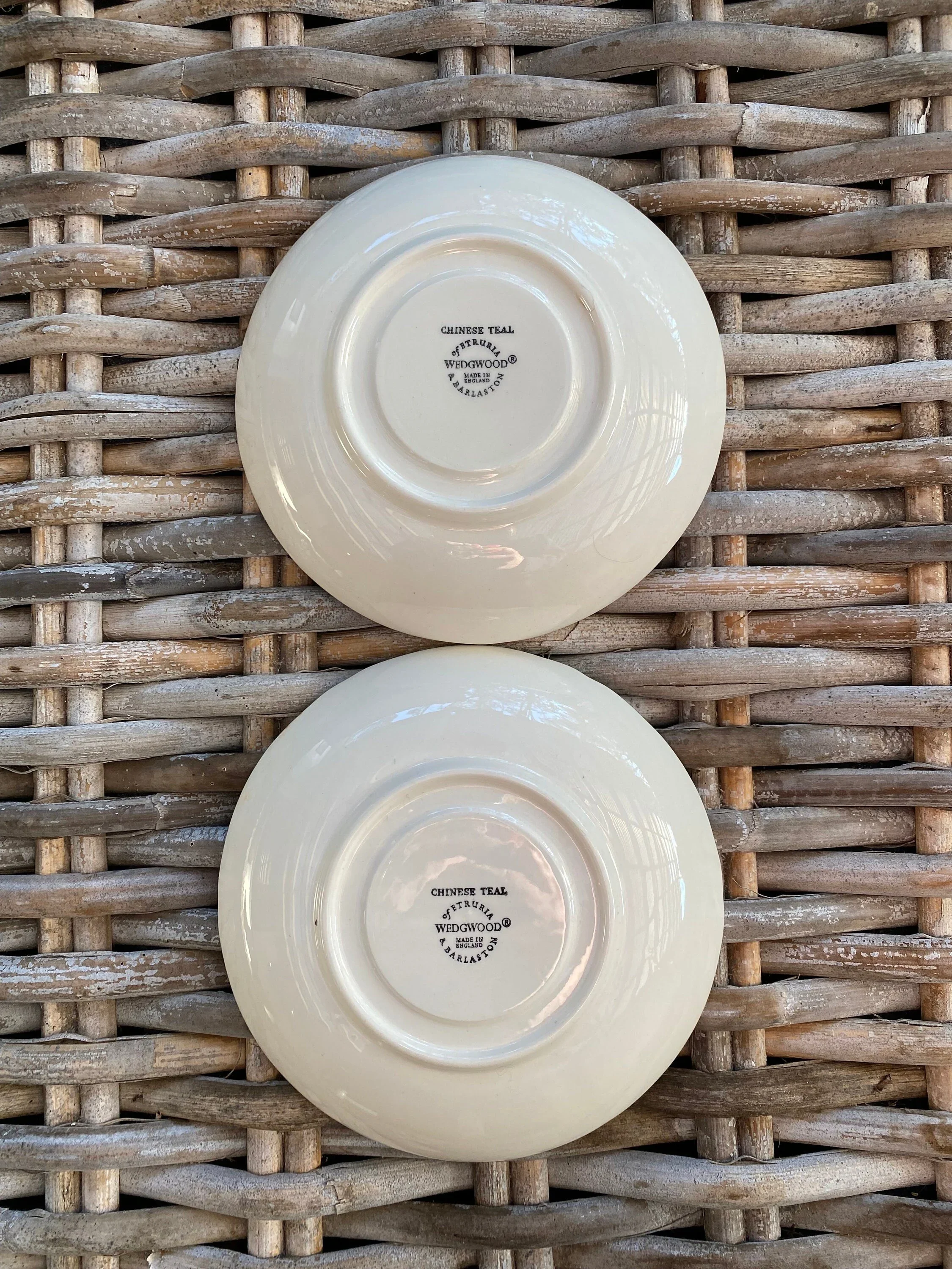 Saucers side by side, showing both backstamps clearly