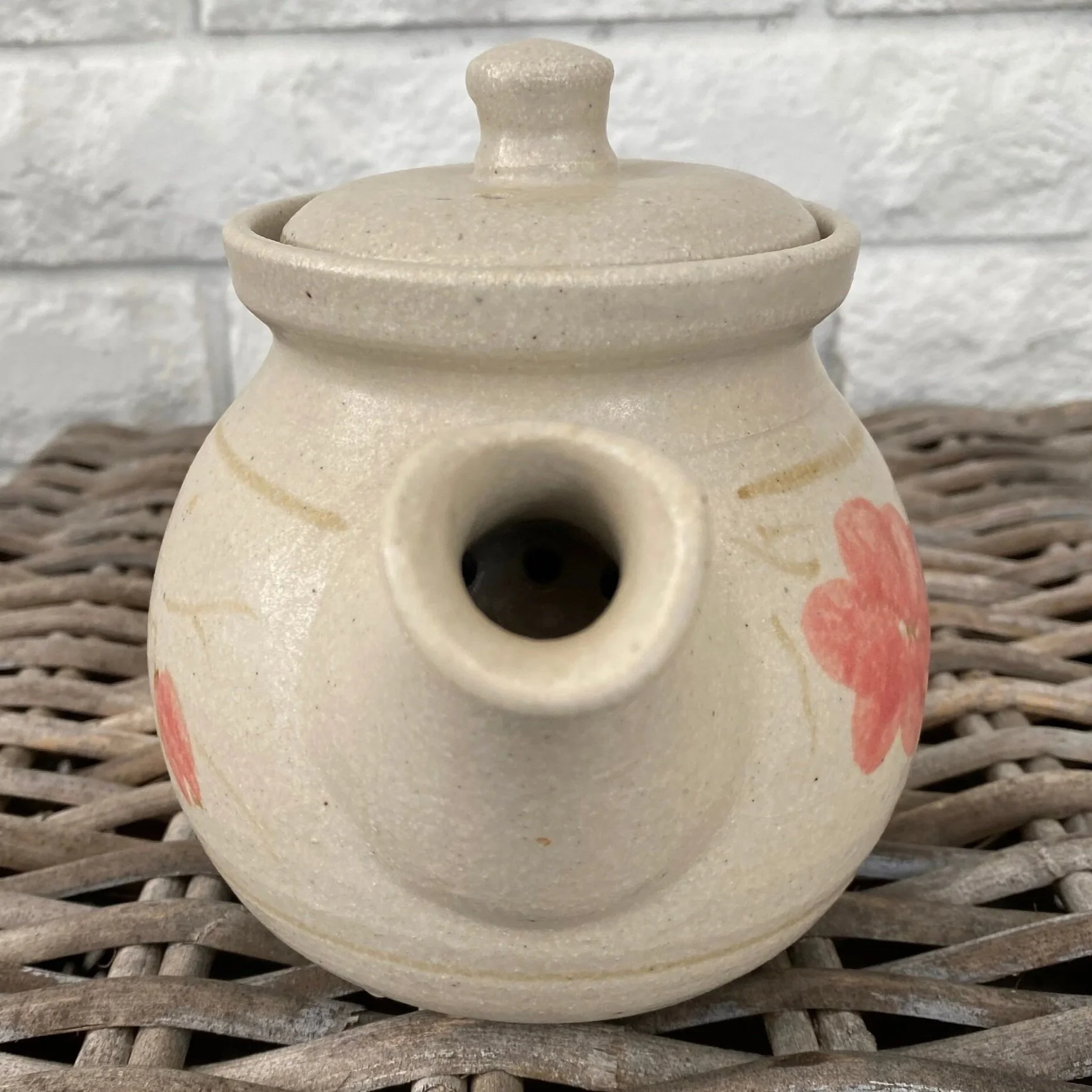 Front view showing spout and painted floral design