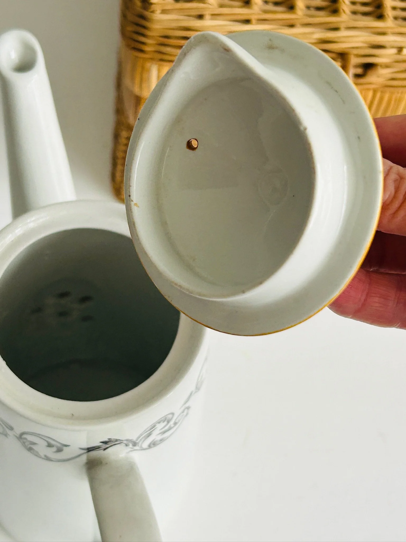 Top-down view of the removed orange lid above the coffee pot opening, showing the interior and lid underside.