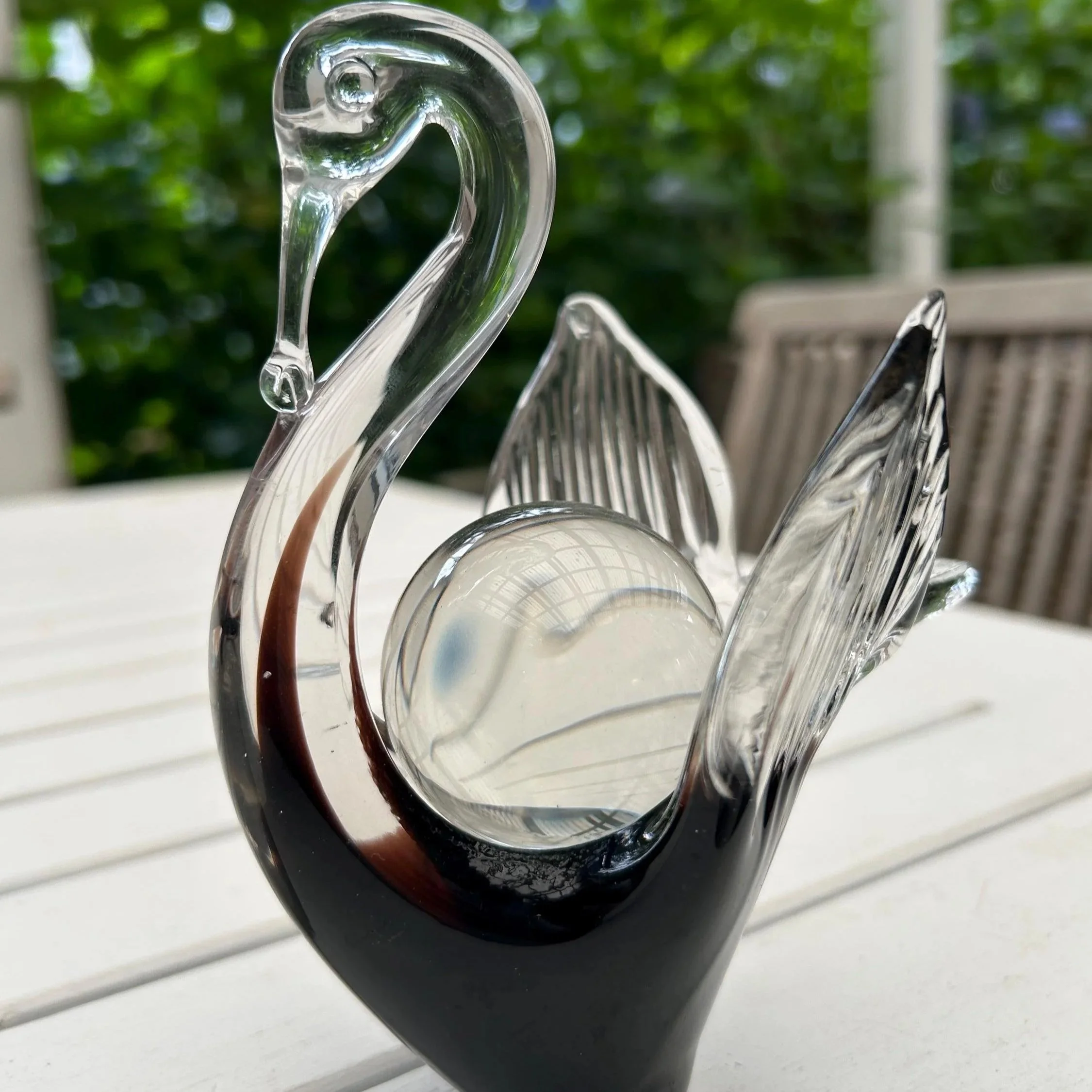 Side view of swan with the sphere resting on its back