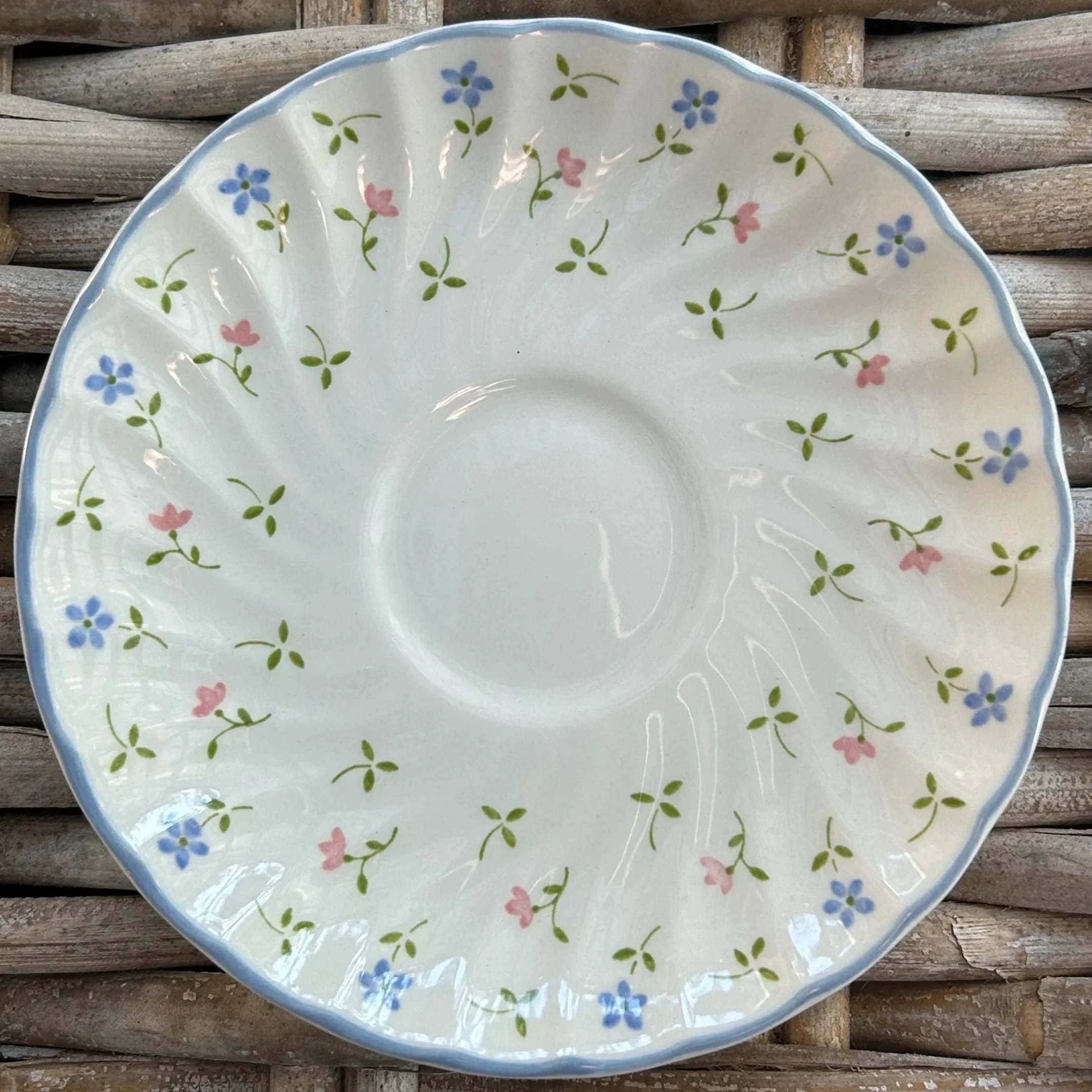Full top view of Johnson Brothers ‘Melody’ saucer with blue rim