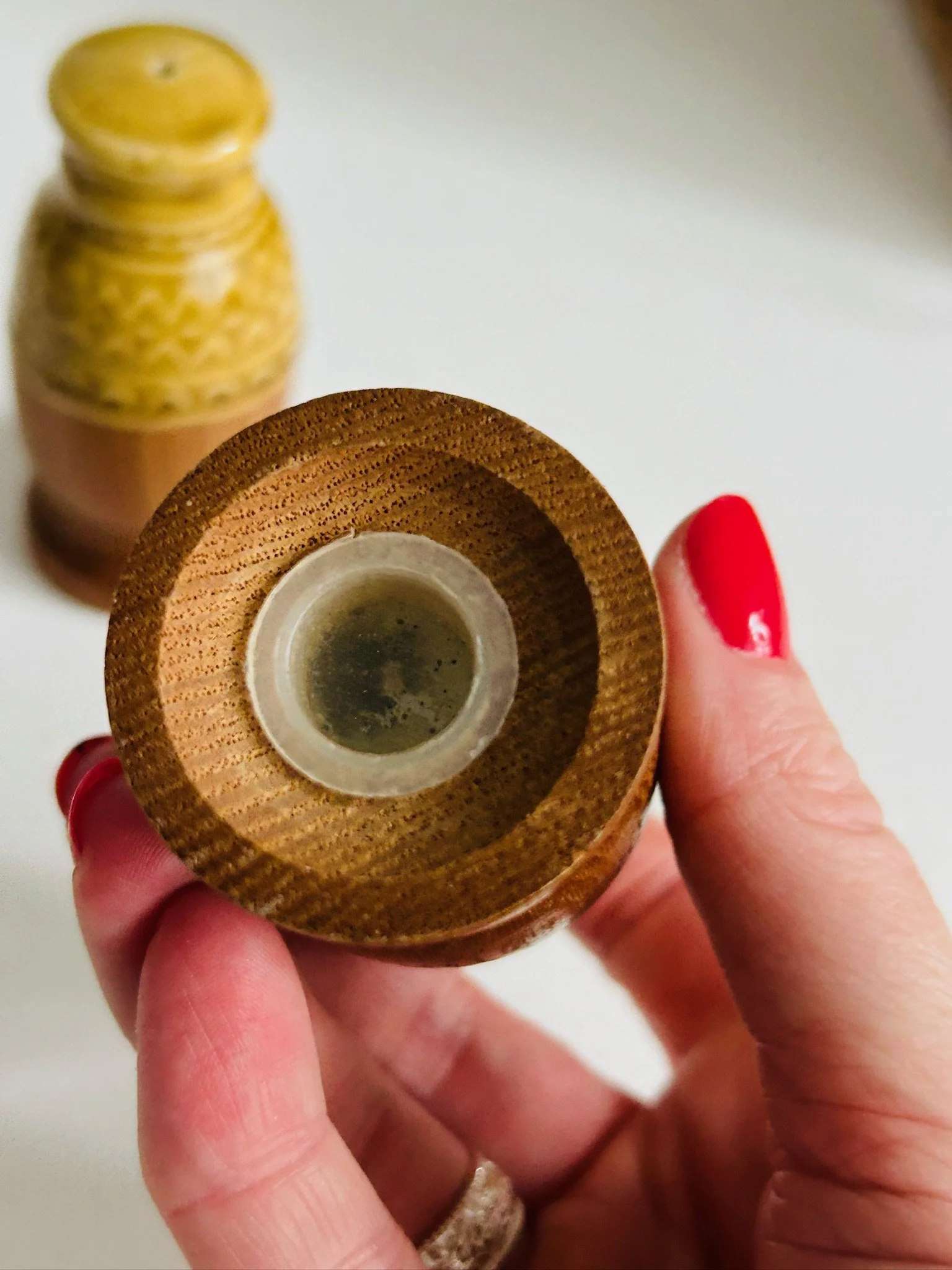 Underside view of one shaker showing the wooden base and stopper insert