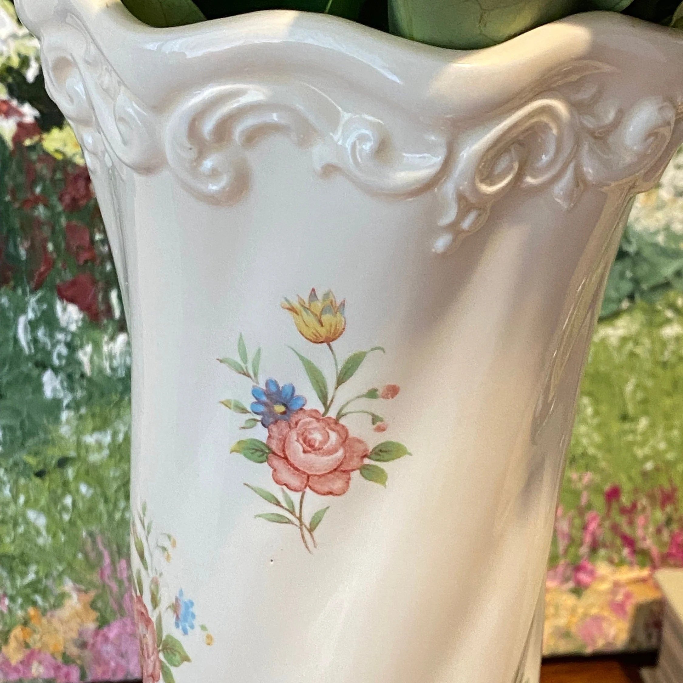 Close-up of floral motif with pink roses and multicolour flowers on white porcelain