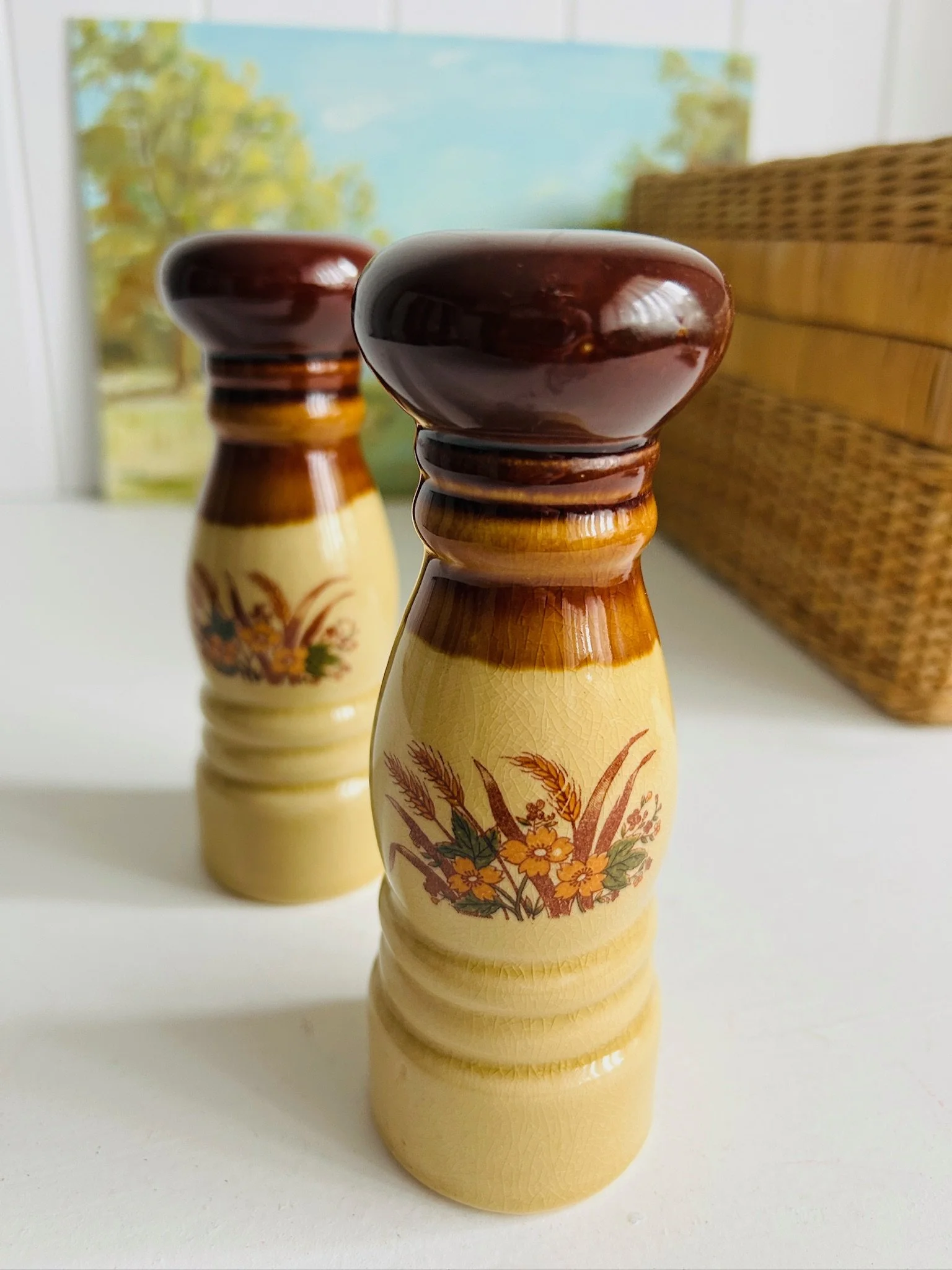 Angled front view of the matching shaker pair with wicker basket background