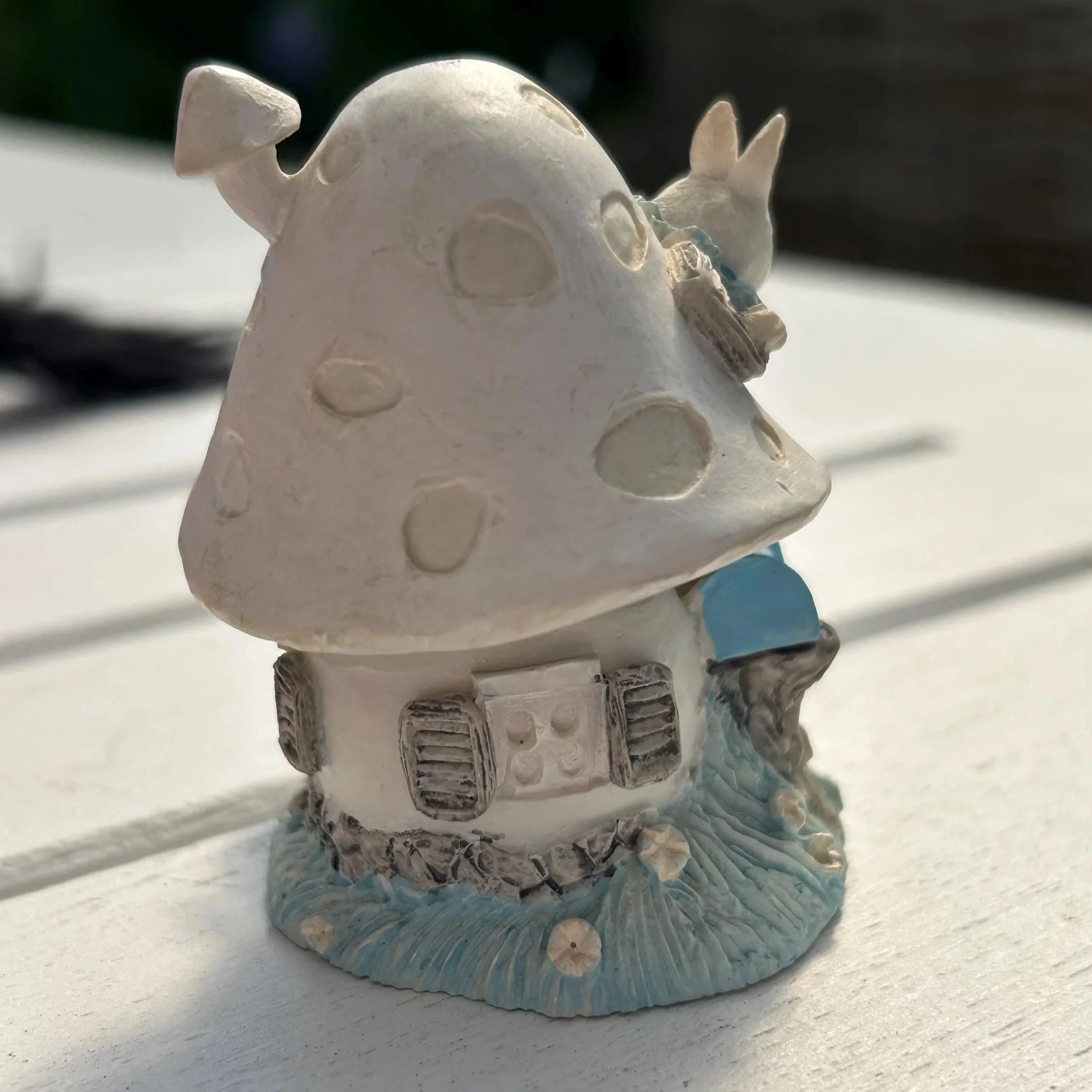 Rear angle of figurine showing full house design