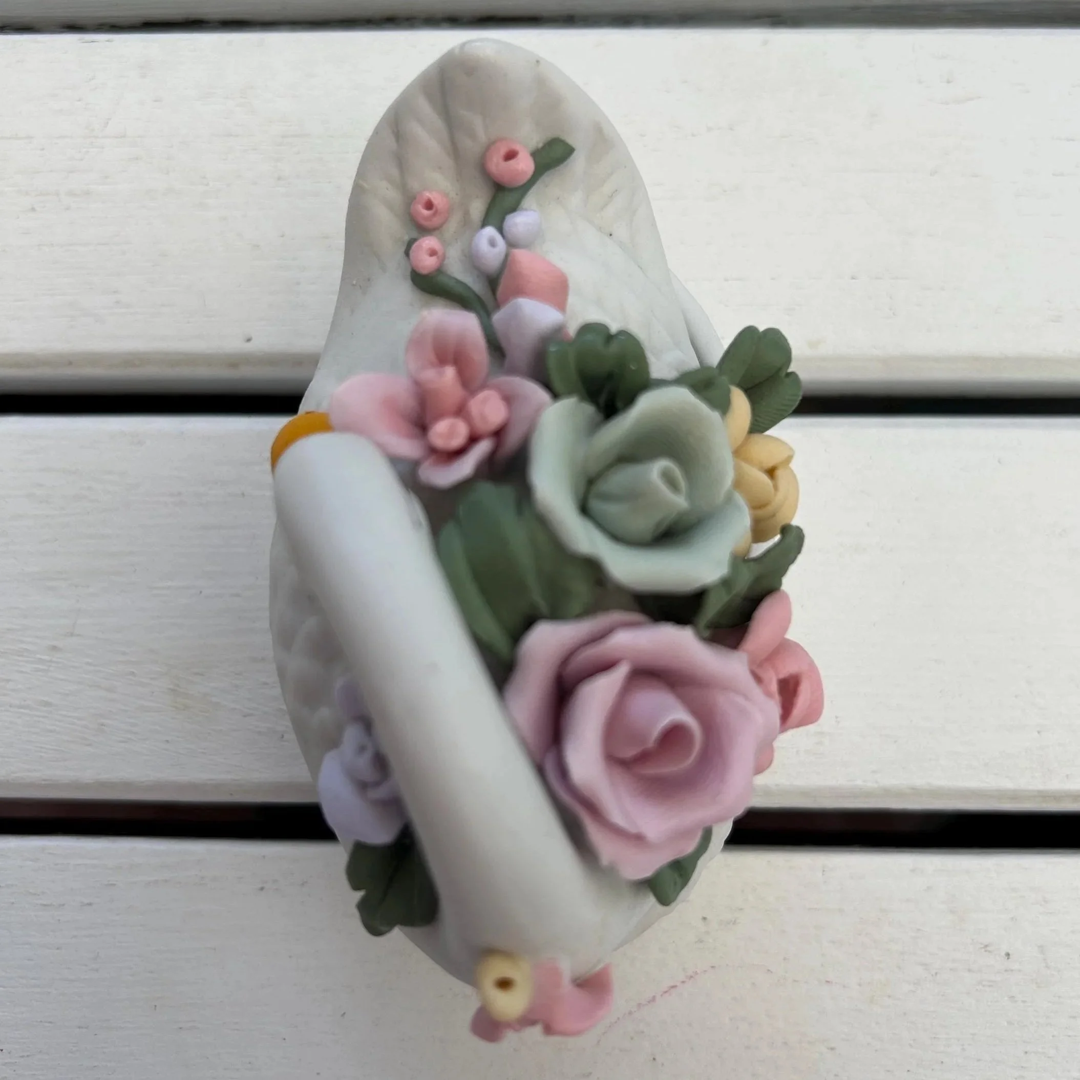 Floral detail with swan against a background of purple hydrangeas