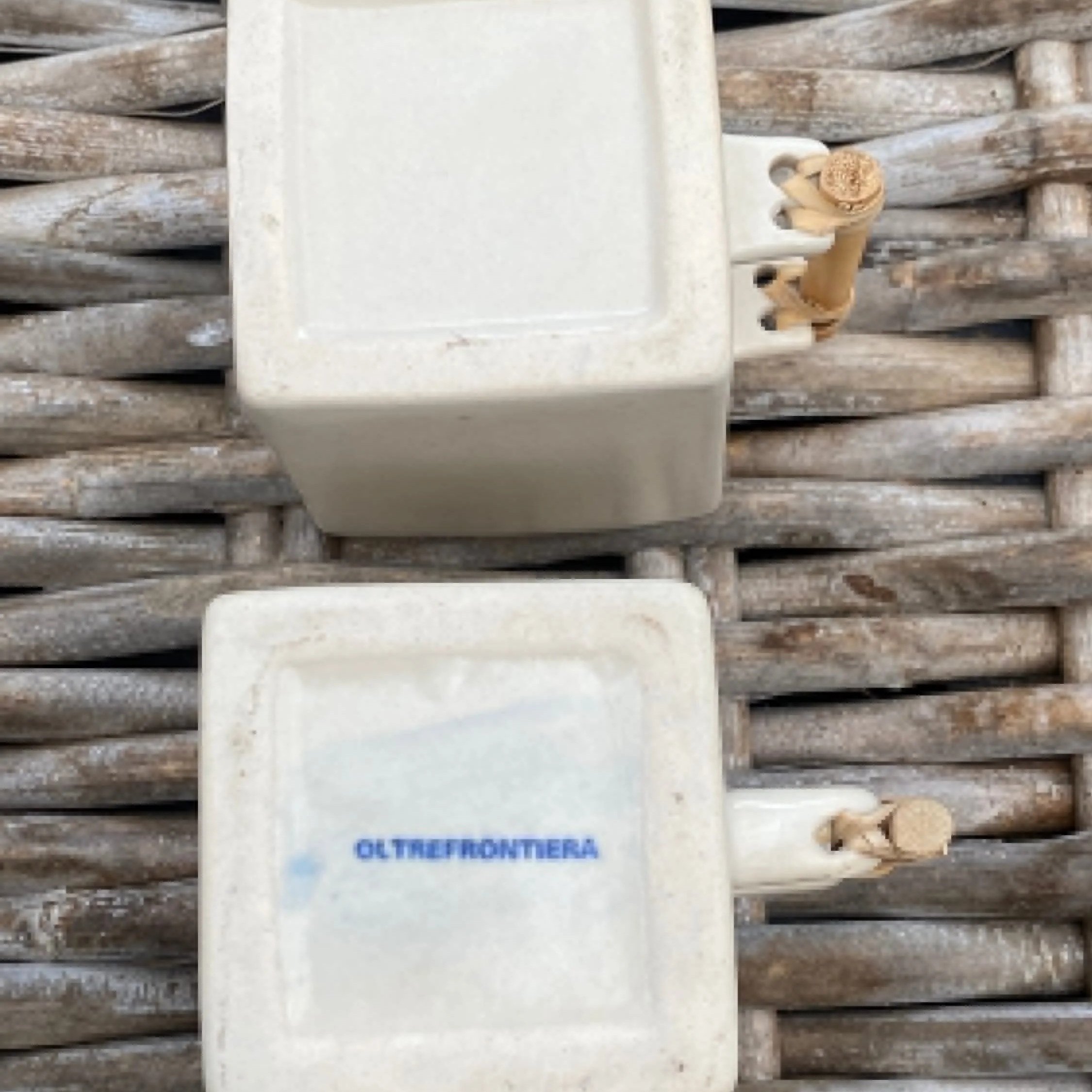 Bottom of cream cups showing "Oltrefrontiera" stamp and bamboo handle