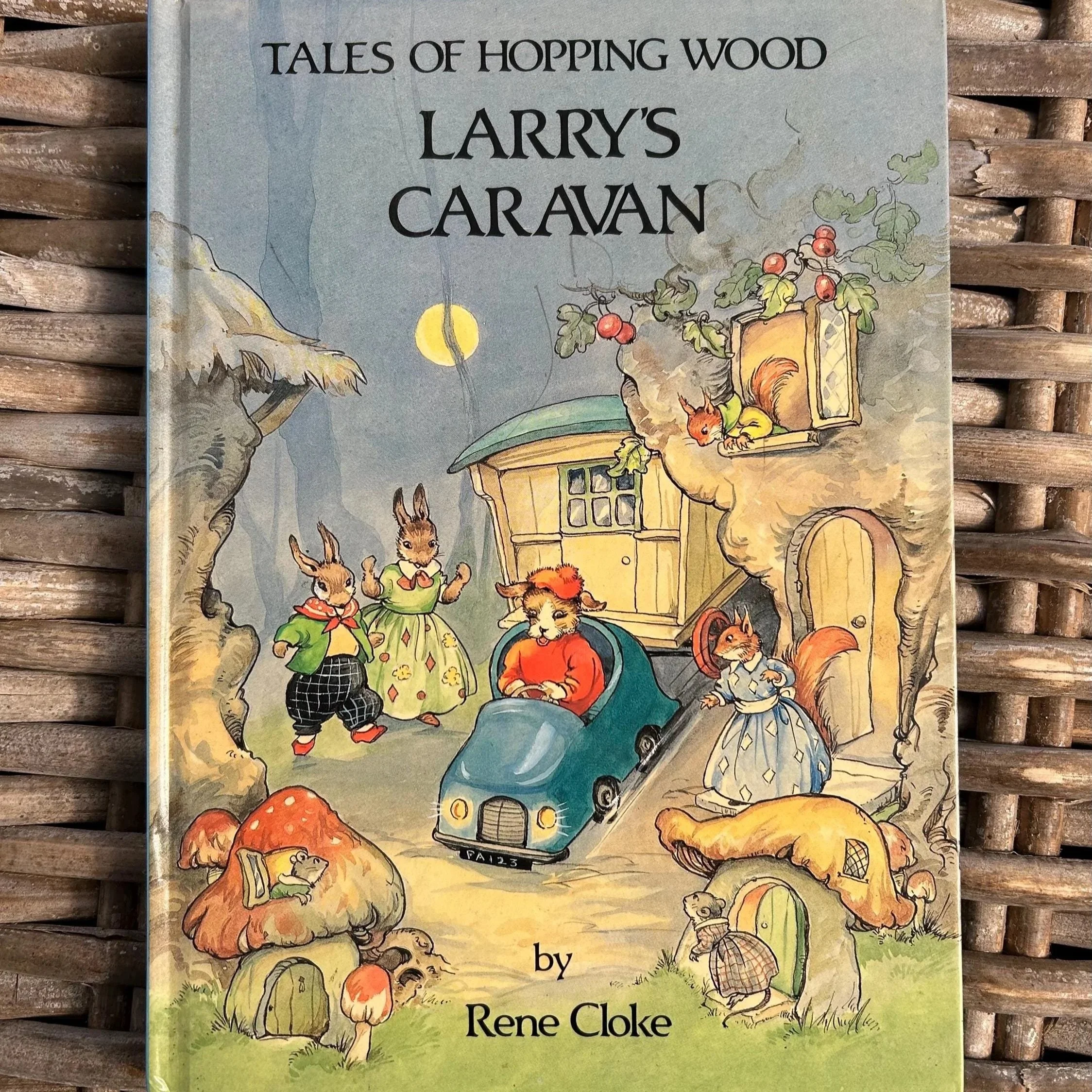 Cover of Larry’s Caravan with anthropomorphic animals and mushroom houses