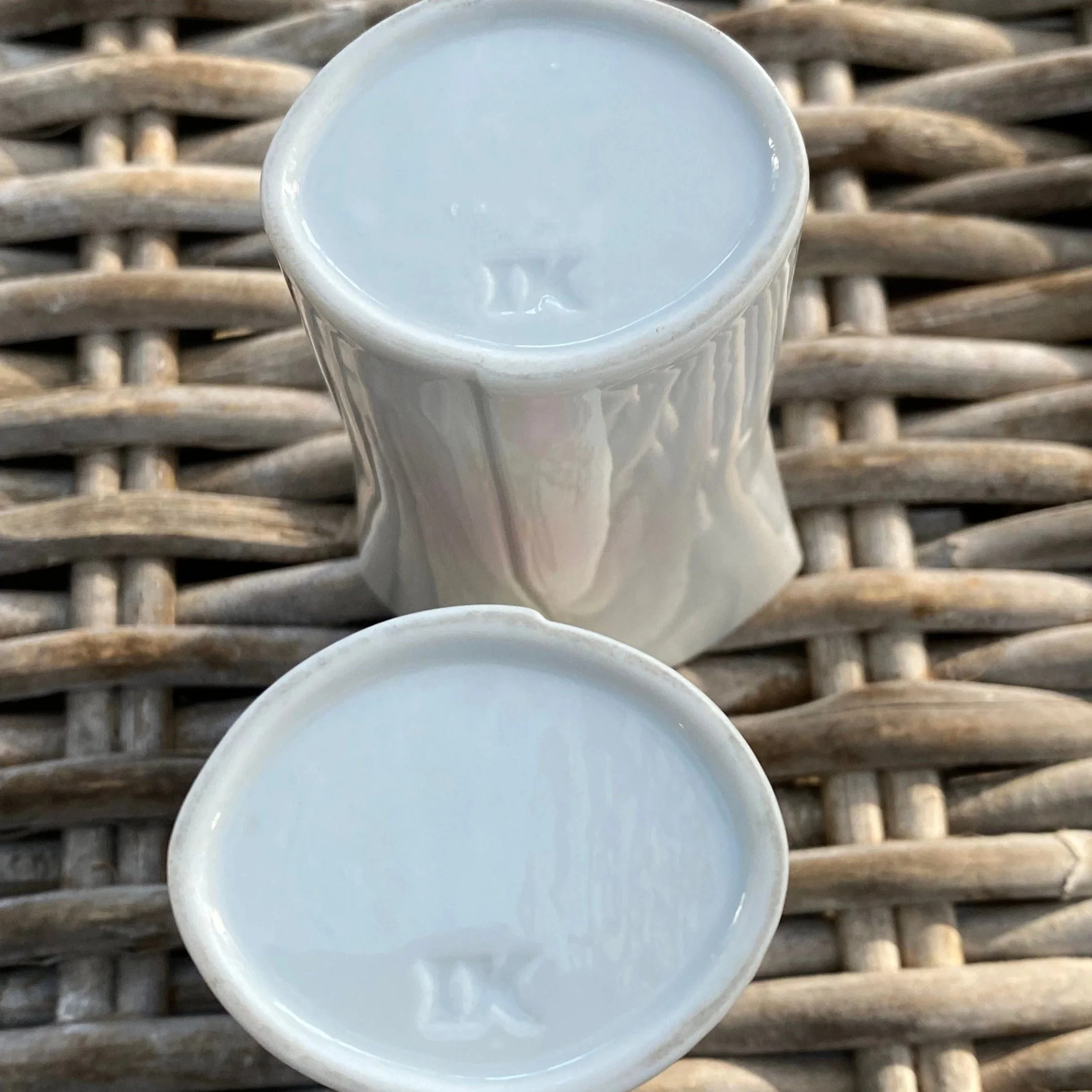 Underside of both vases revealing “IK” maker’s mark