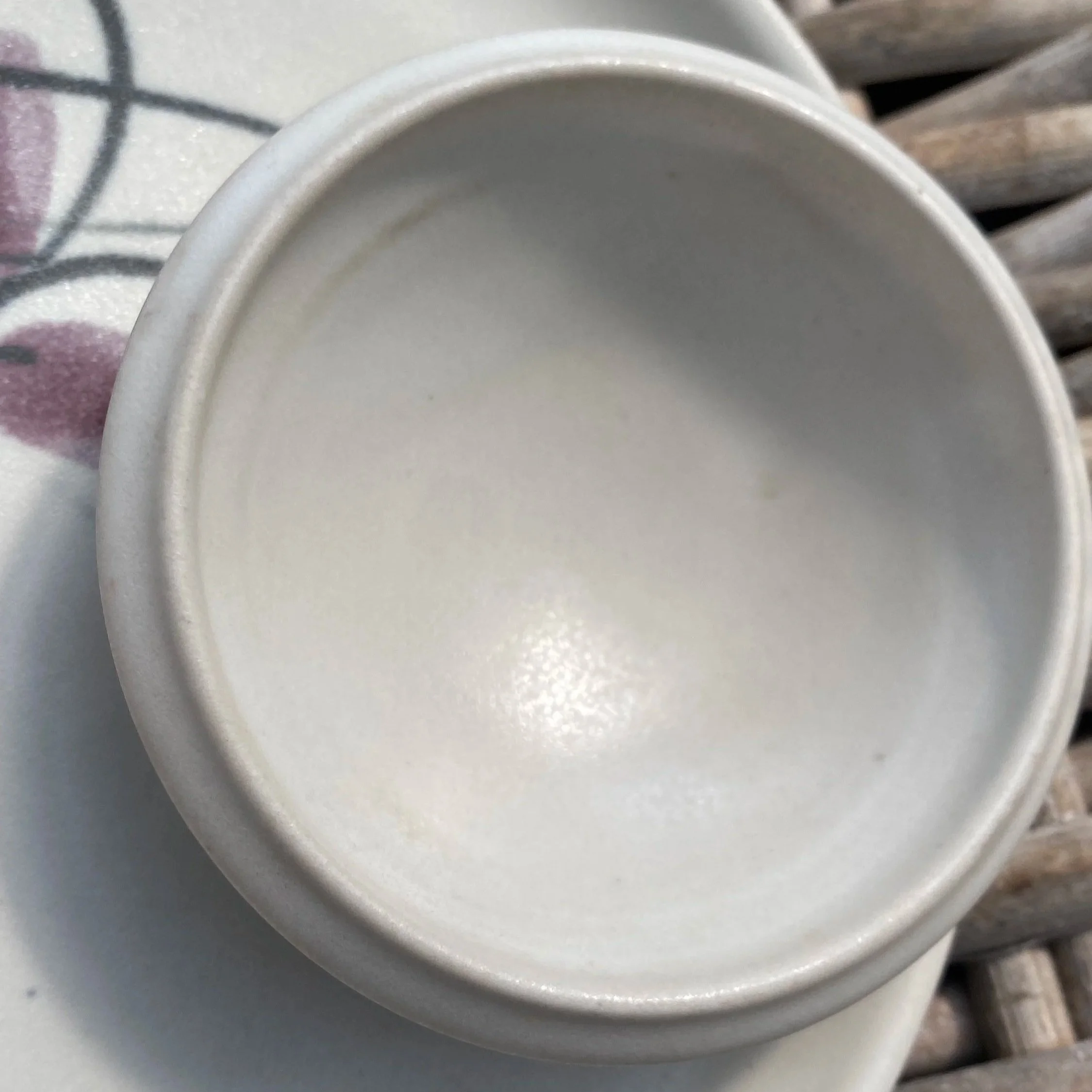 Interior of the small dip bowl with smooth cream glaze