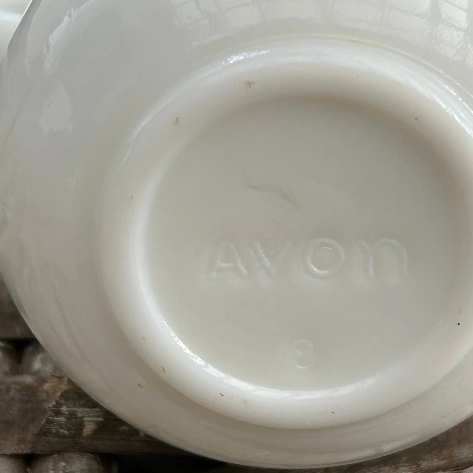 Underside of pitcher showing embossed "AVON" marking
