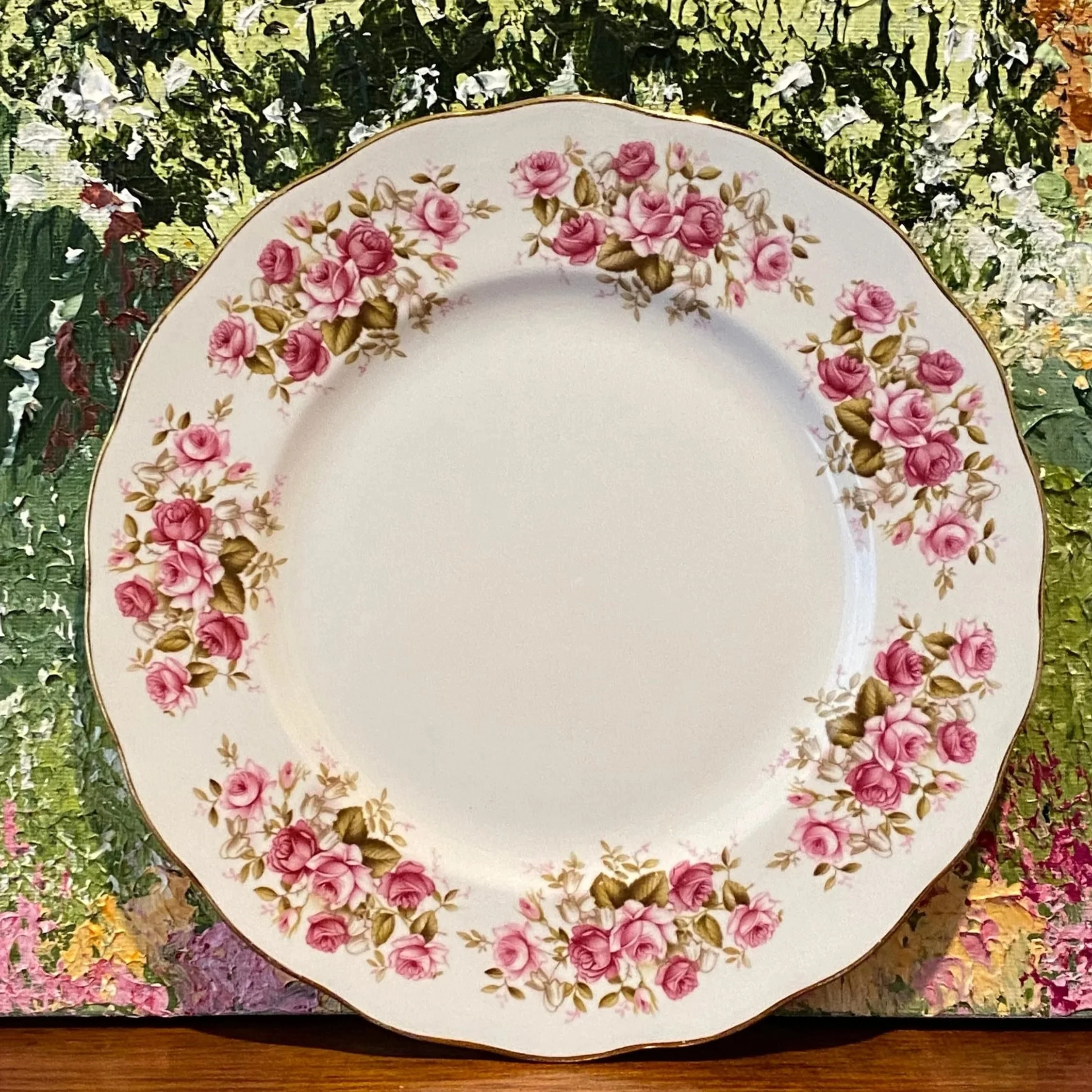 Full front view of Queen Anne Rose Garden plate against floral background