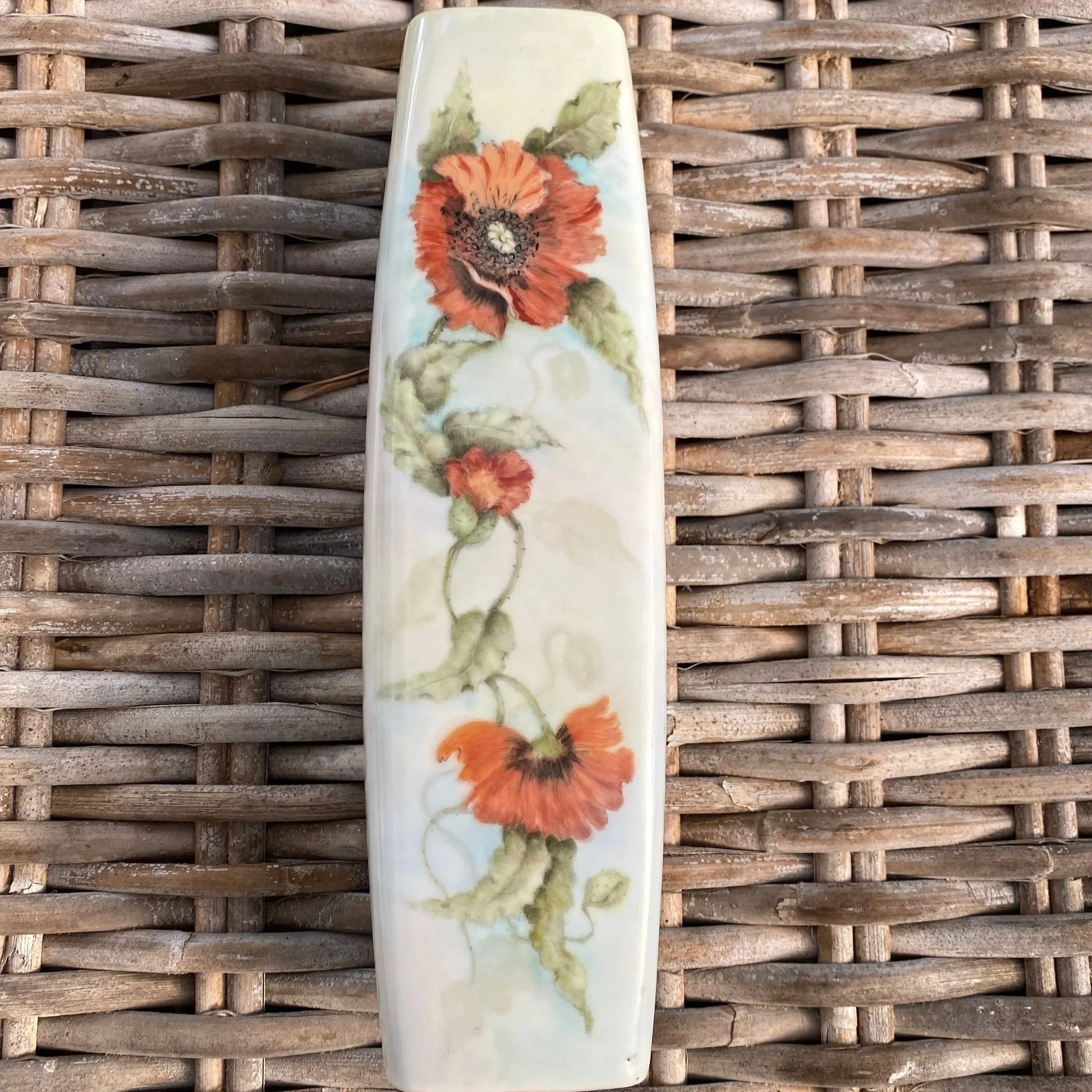 Full front view of tall porcelain vase with hand-painted poppies