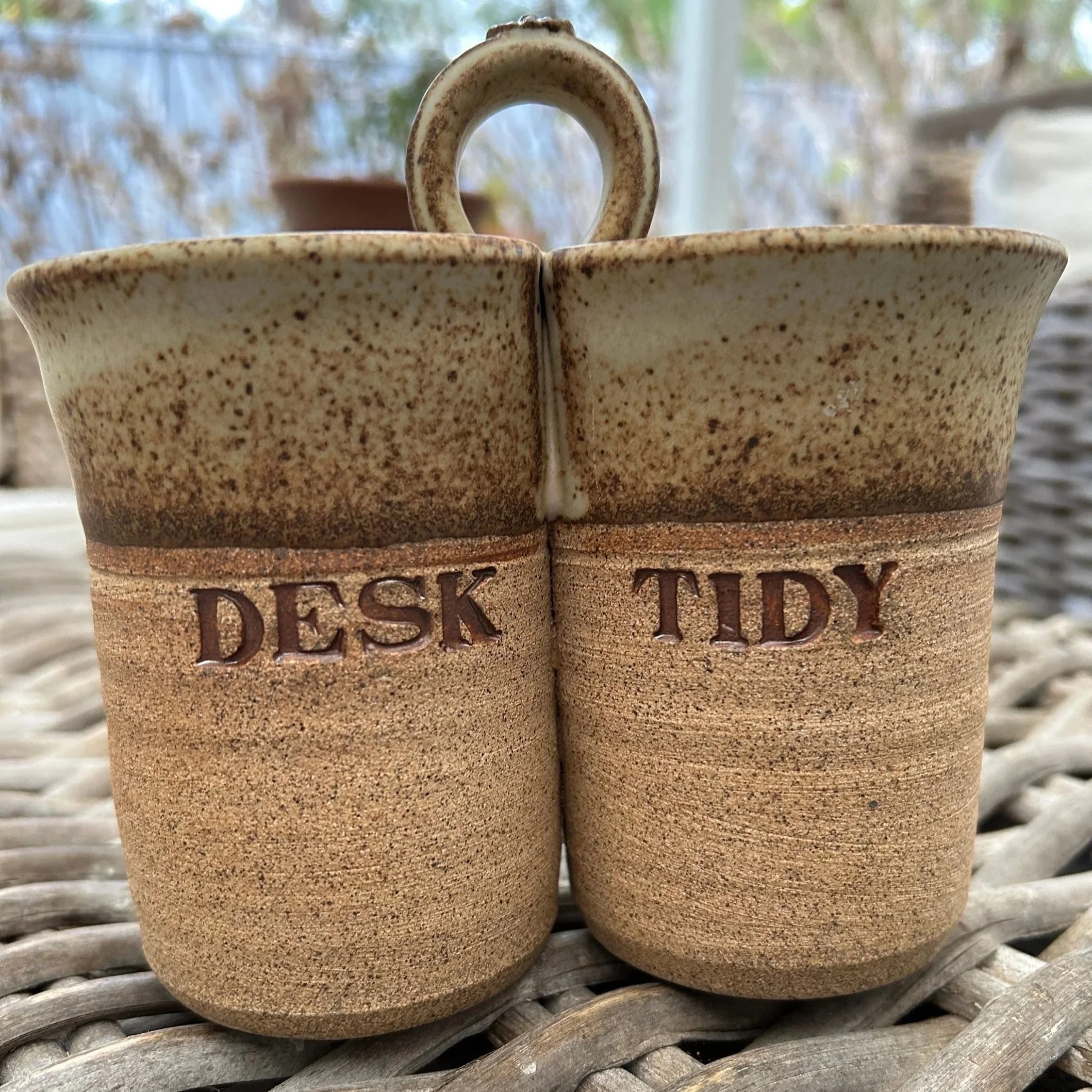 Front view of rustic ceramic desk tidy with “DESK” and “TIDY” impressed lettering