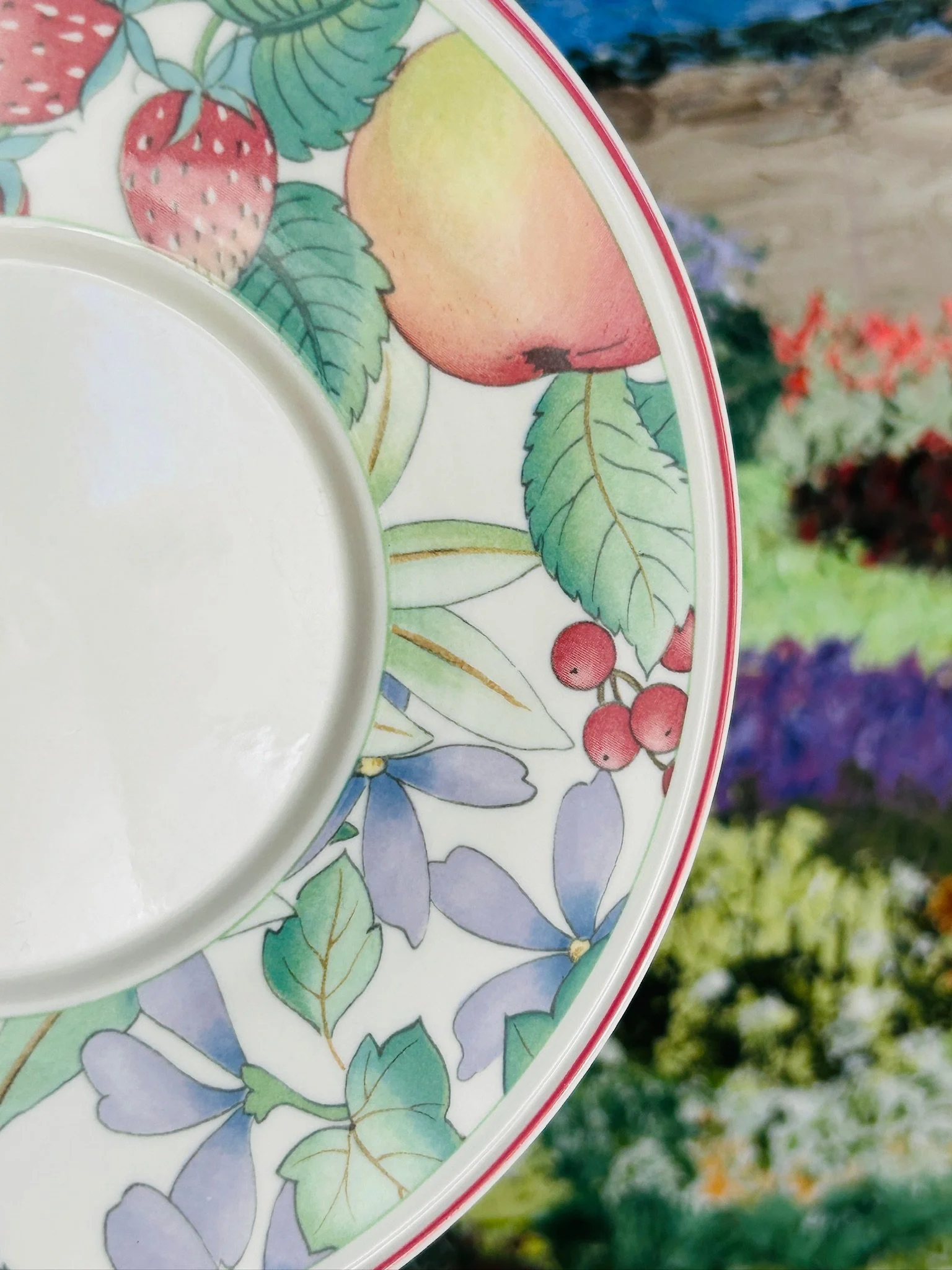 Detail of the saucer beside the cup base, showing the colourful Catalina pattern and clean white porcelain centre.