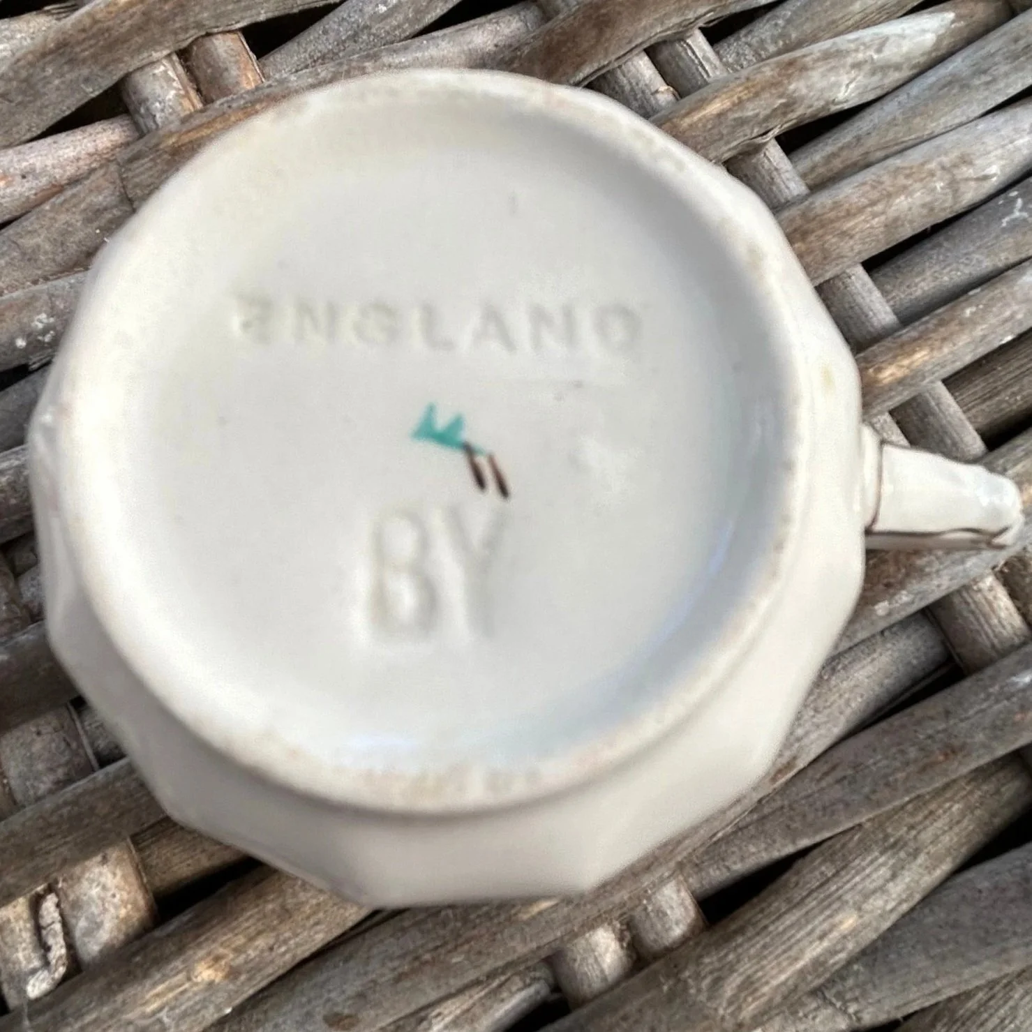 Underside of cup marked “ENGLAND BY” with impressed letters and glaze wear