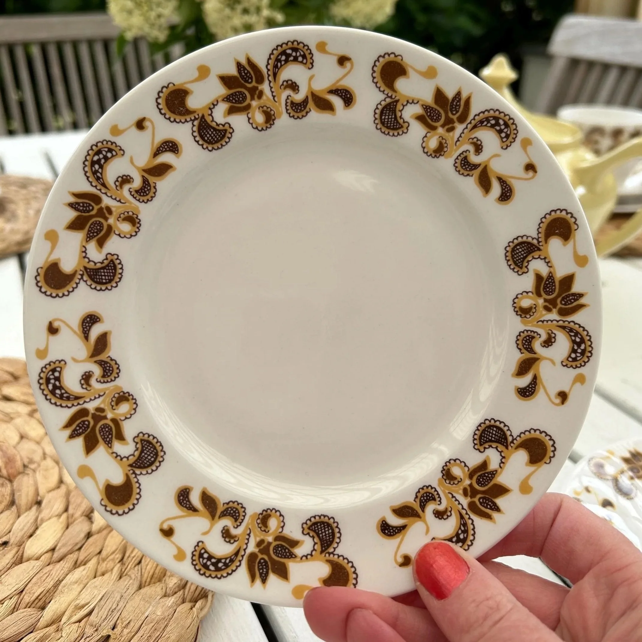 Side plate with matching pattern shown in hand