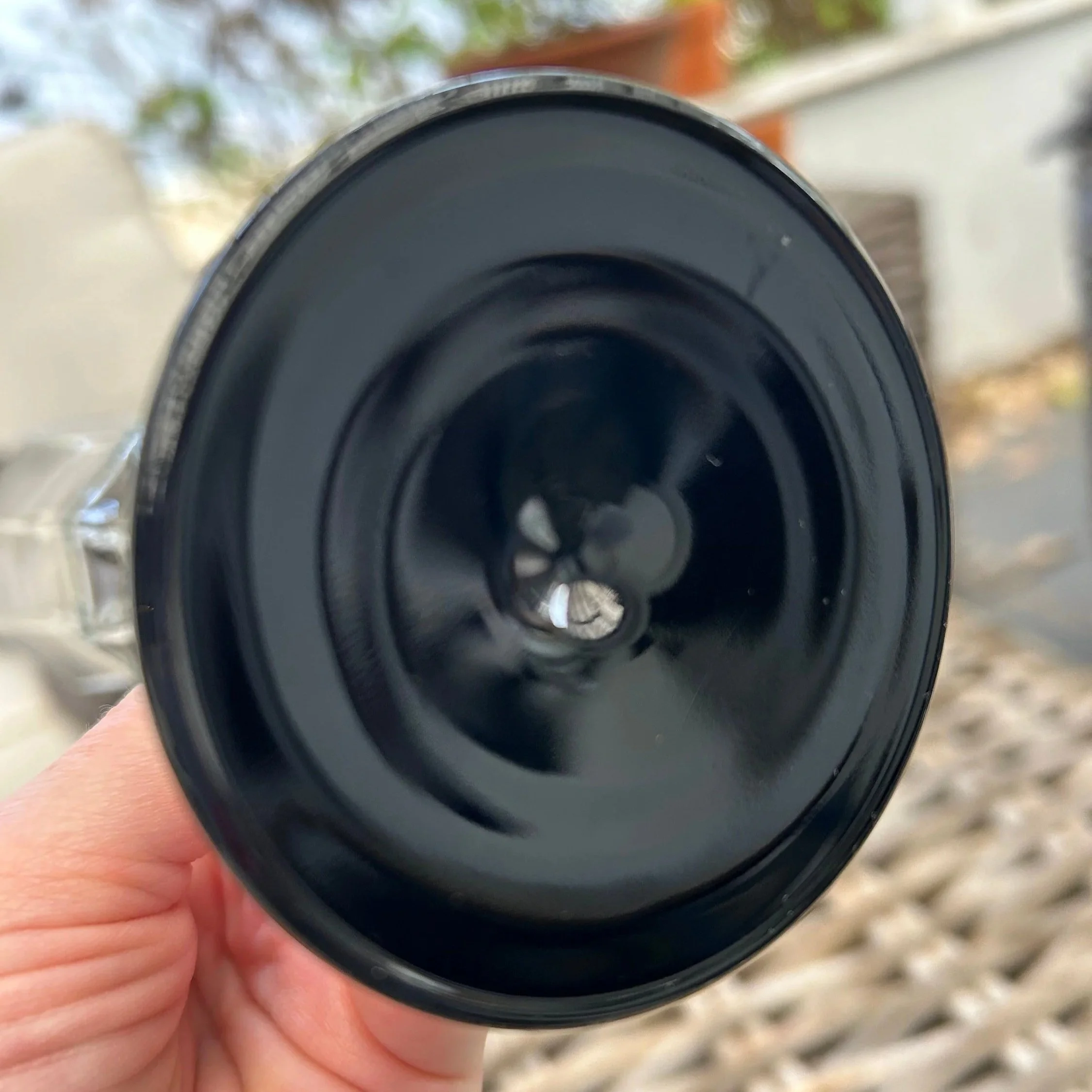 Base close-up showing glossy black circular foot