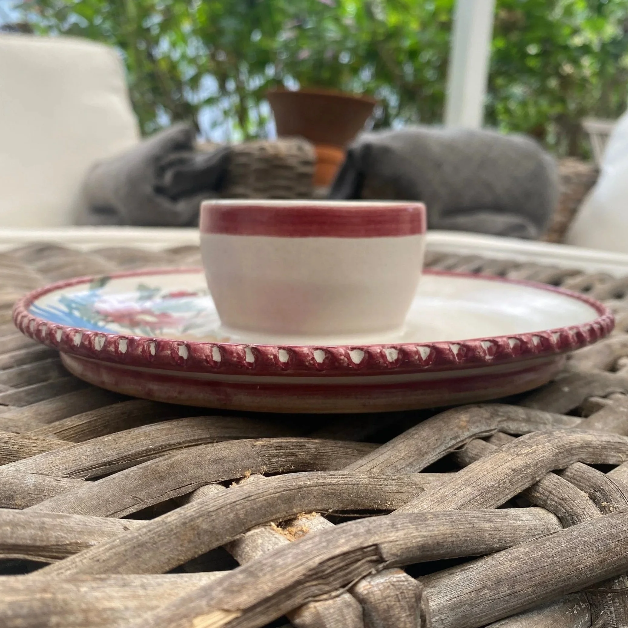 Side angle showing dip bowl sitting inside the dish with floral rim detail