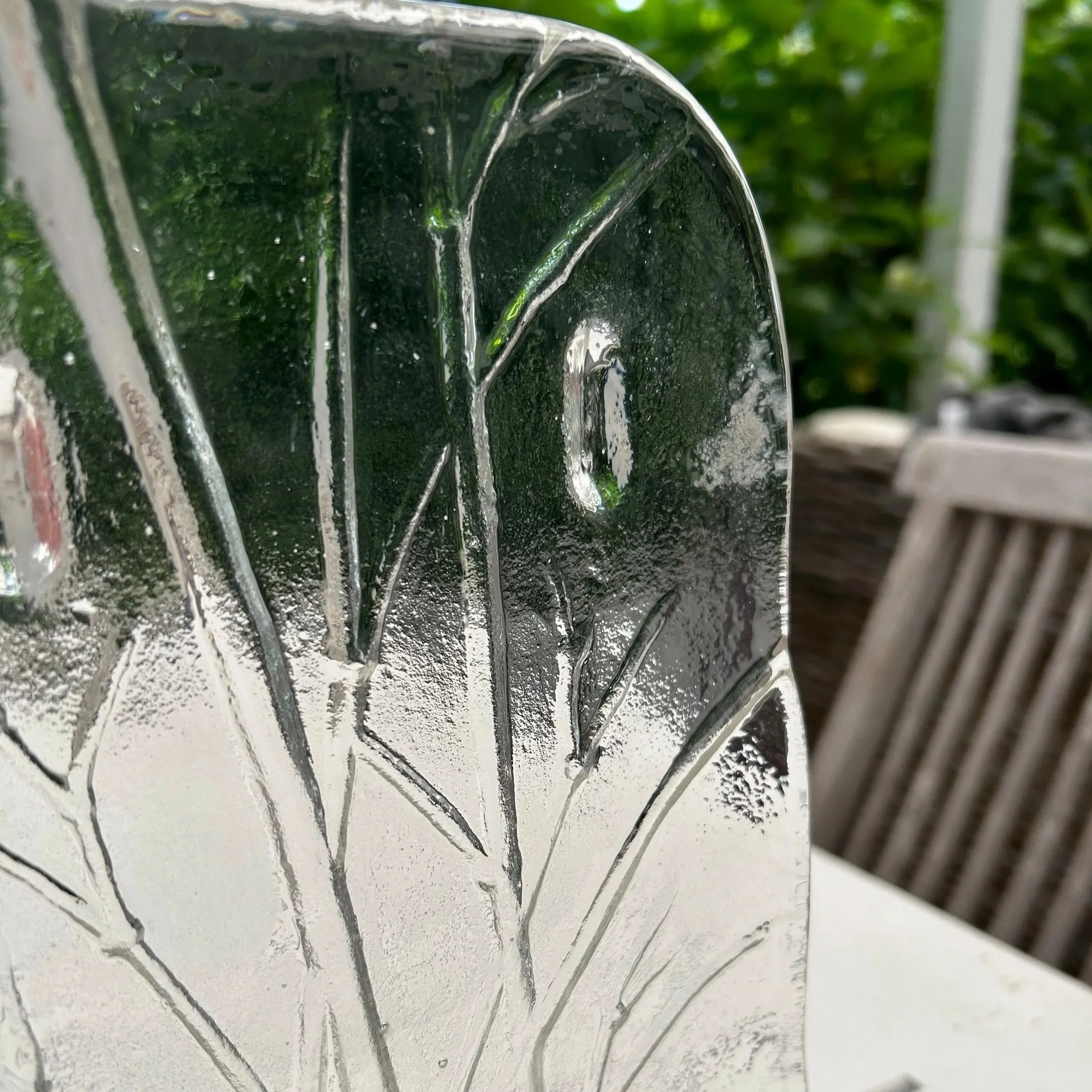 Close-up of the bamboo-textured surface of the tray, upright against greenery