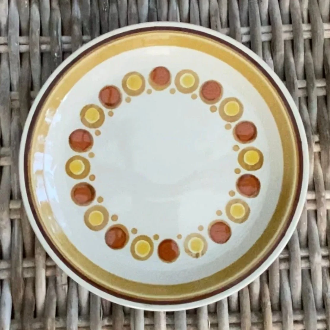 Top-down view of Electra Stone Ware “Carnival” plate showing full pattern