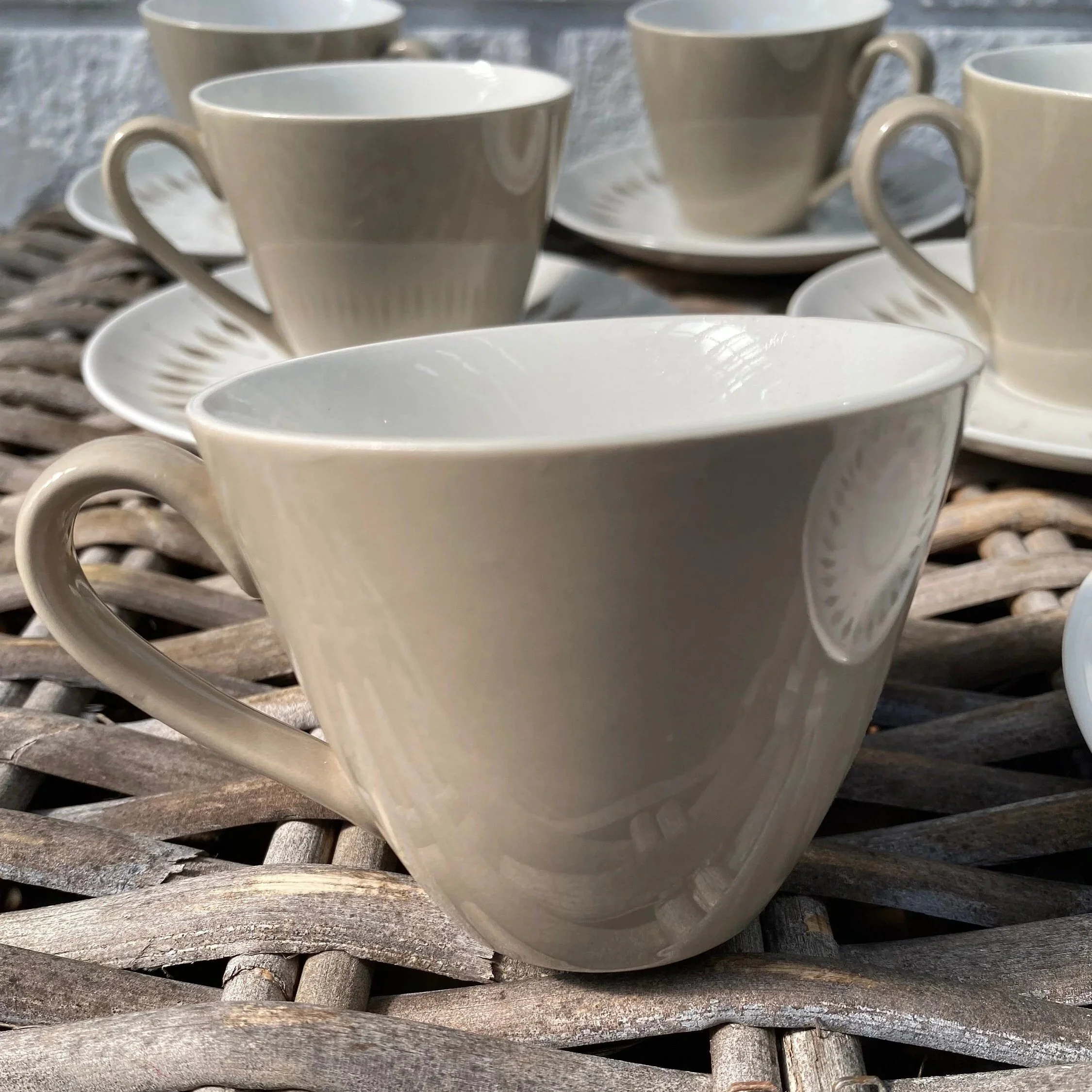 Close-up of teacup showing clean glaze and soft taupe design