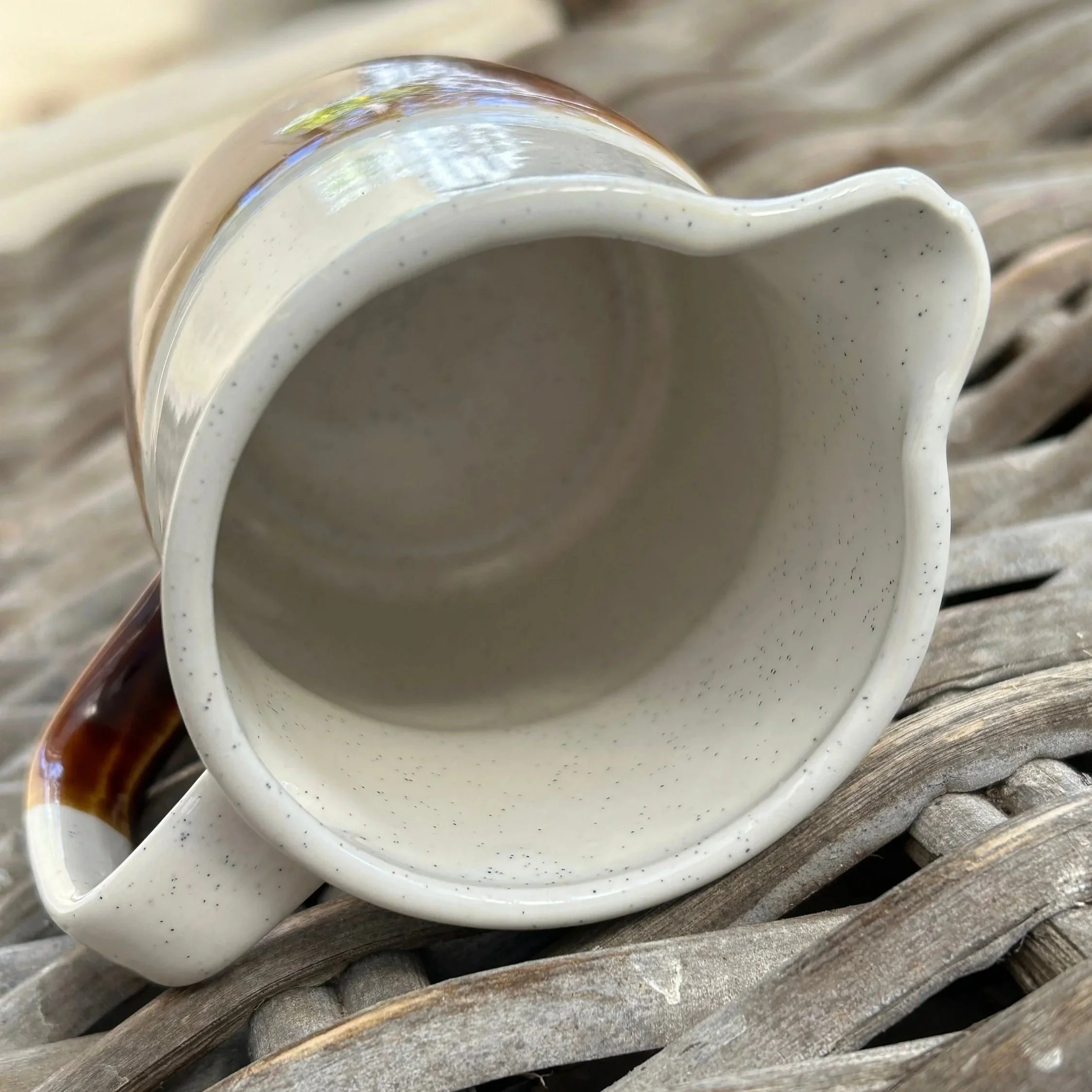 Top view into the ceramic creamer showing the clean interior and shaped pouring spout