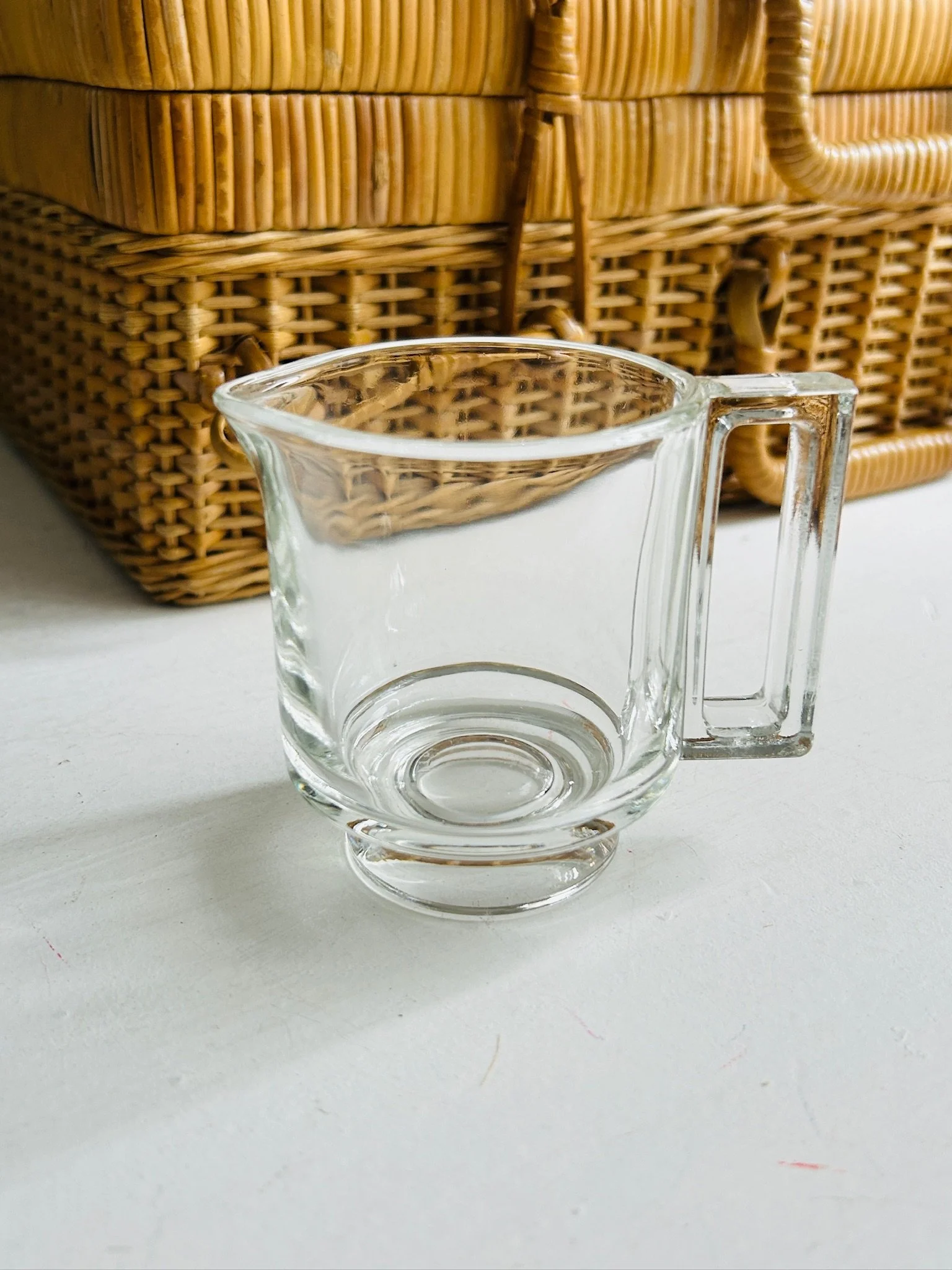 Vintage clear pressed glass creamer by Arno designed by Joe Colombo, shown front facing with pouring spout and square D handle visible