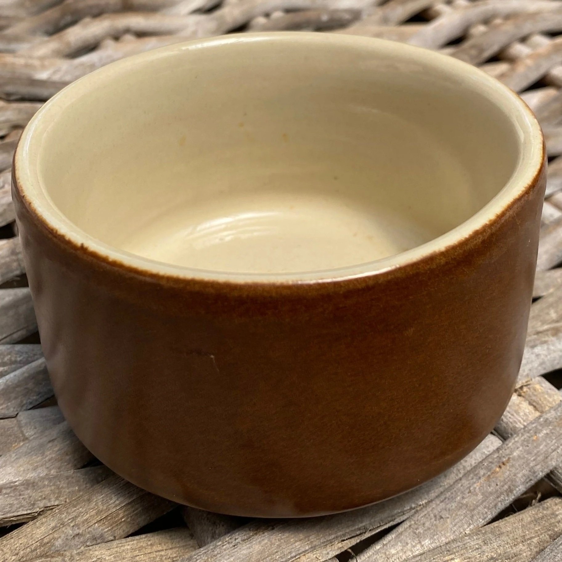 Side view of handcrafted stoneware bowl showing glossy brown glaze