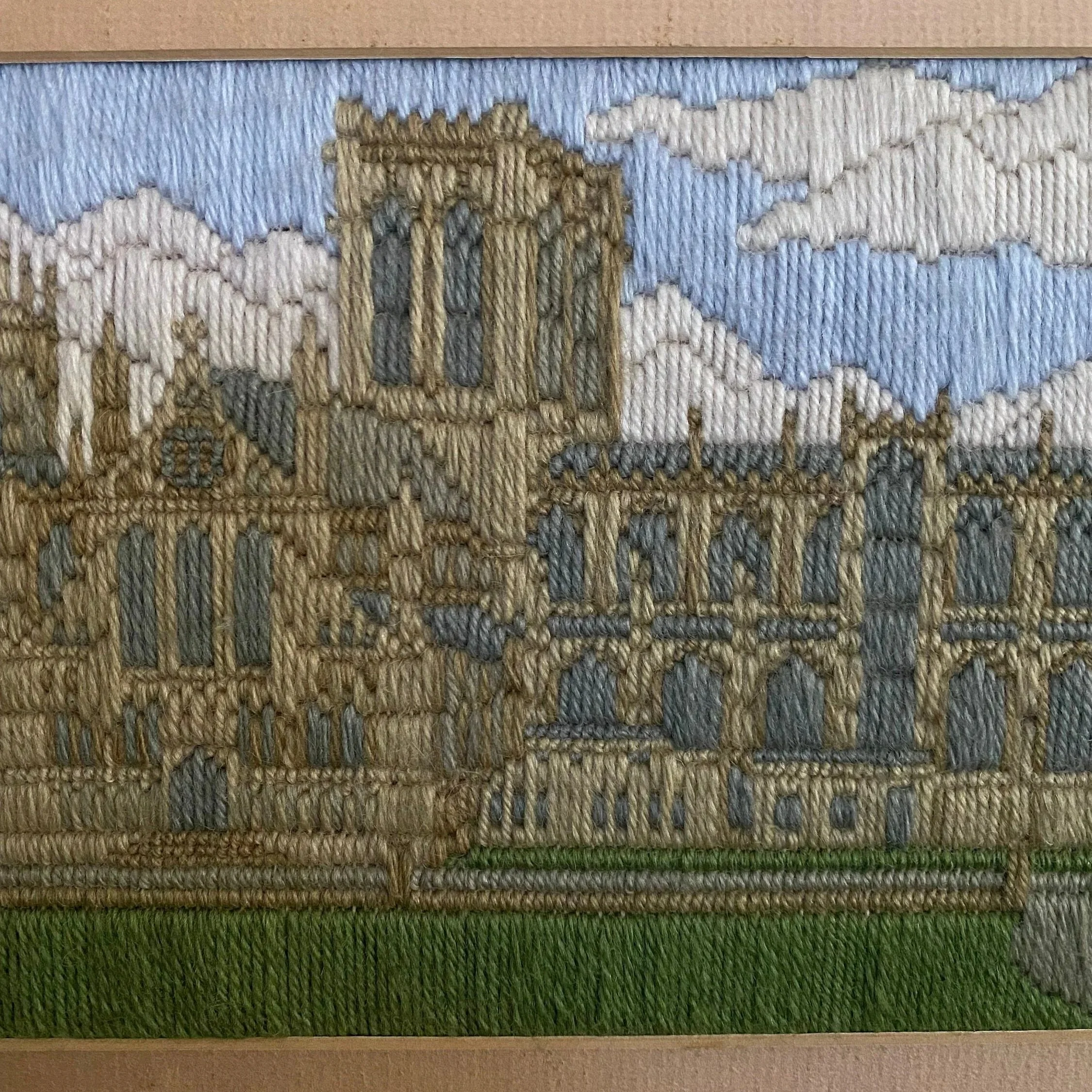 Close-up of the stitched York Minster design showing the cathedral towers, clouds, and detailed threadwork