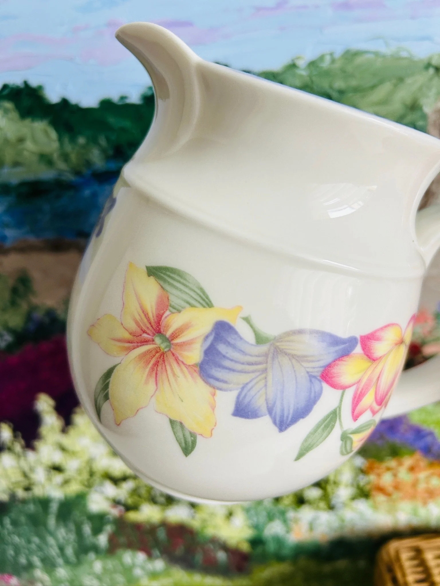 Angled view of the jug showing handle, spout, and full floral pattern