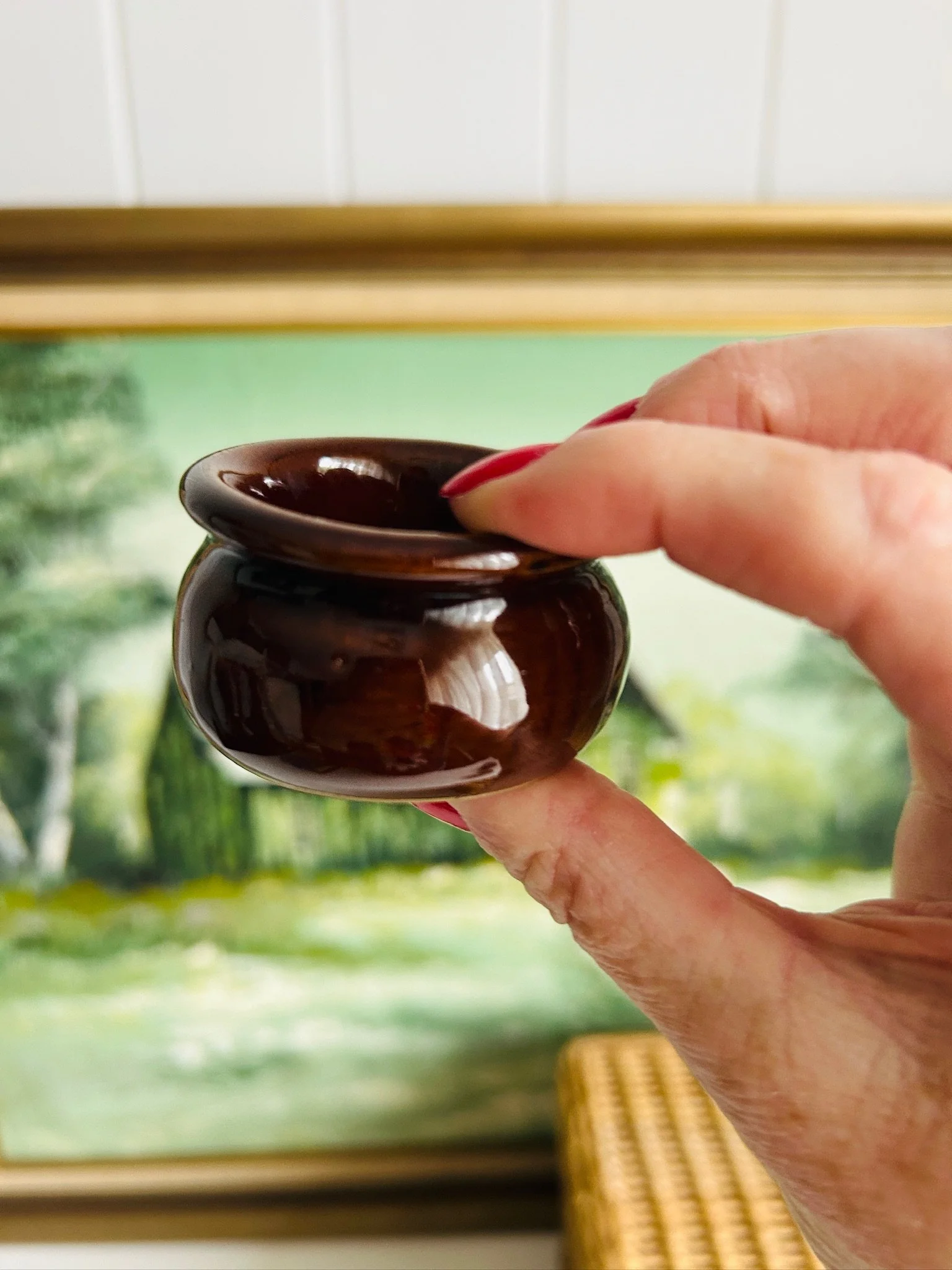 Hand holding the small Moira Pottery salt cellar from the side to show its curved body and scale
