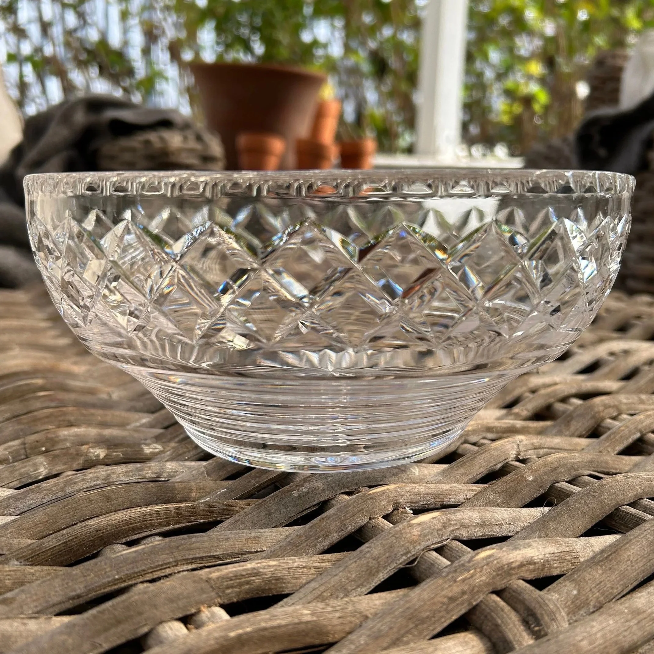 Side view of vintage Stuart Crystal bowl with Stratford Rings cut pattern on outdoor table