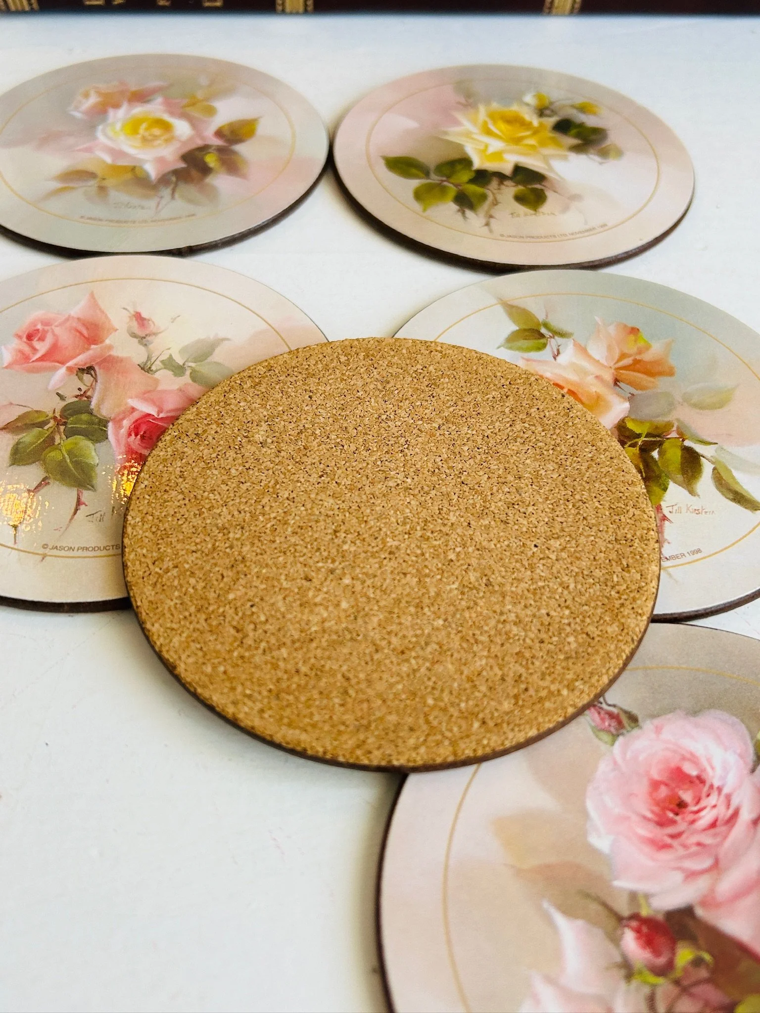 Reverse of a Jason rose placemat showing the natural cork backing, surrounded by the rose print fronts