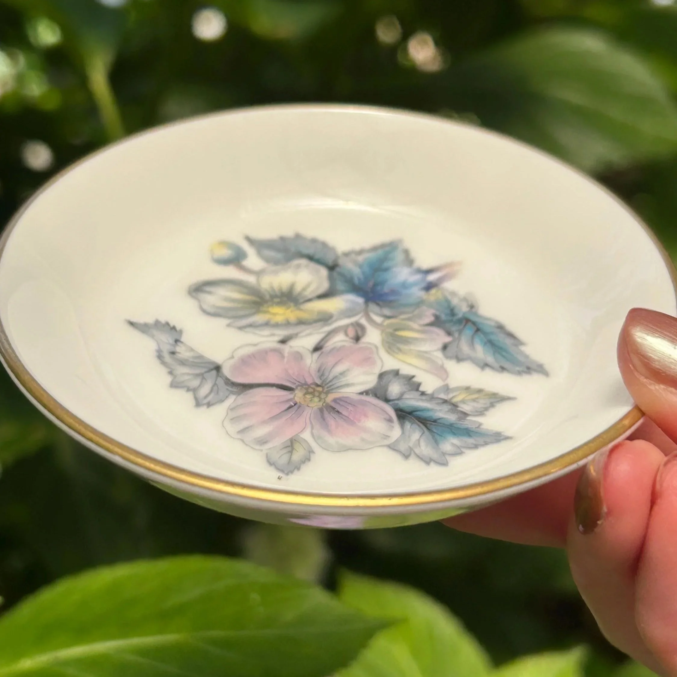 Angled view of dish showing floral motif and gold edge detail