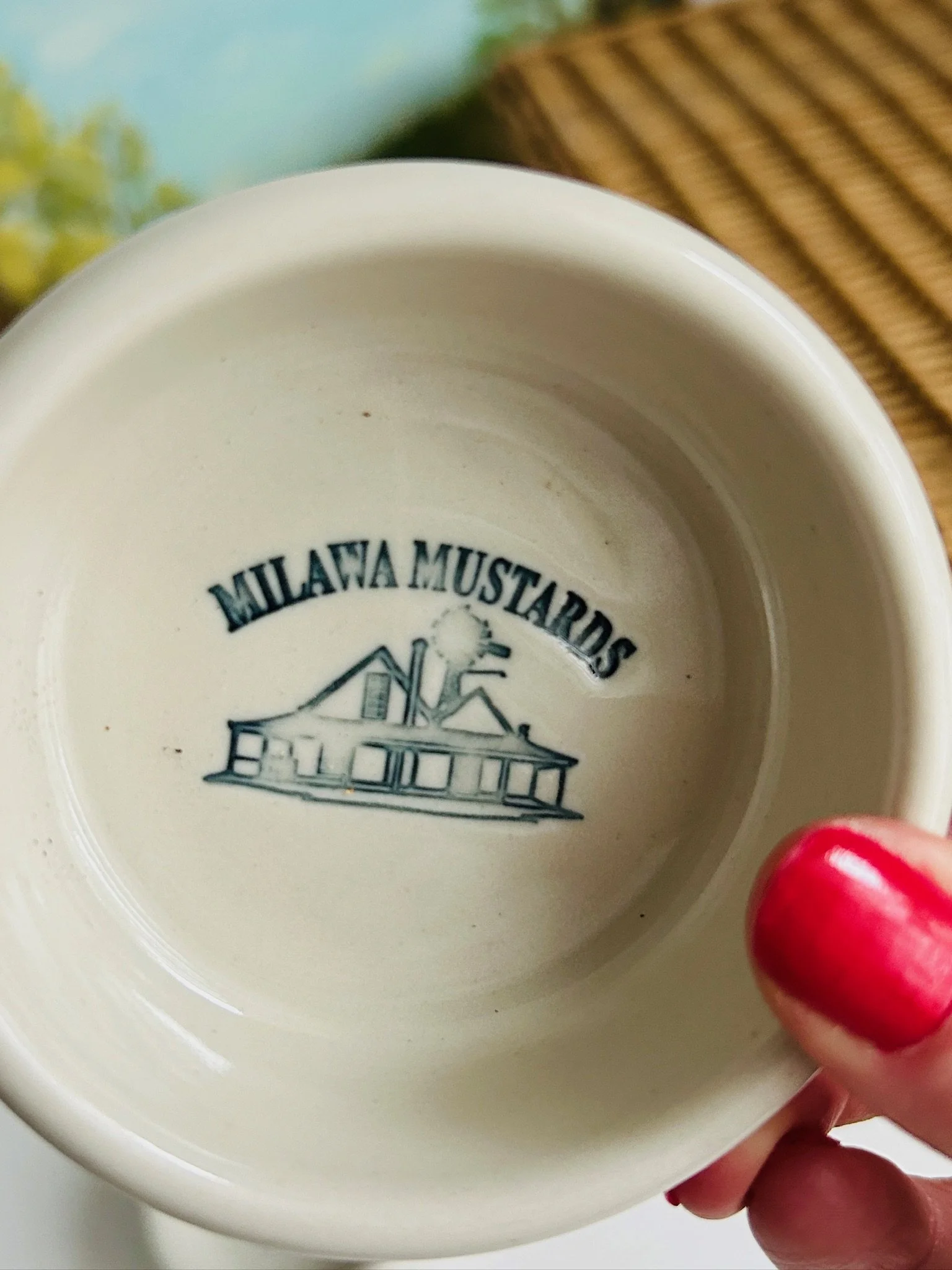 Close-up of one cream stoneware bowl interior with Milawa Mustards logo