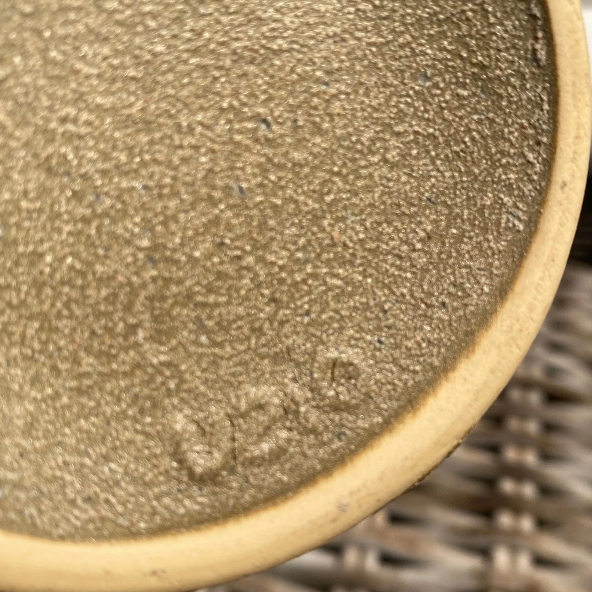 Close-up of base showing ‘U210’ stamp impressed into unglazed clay