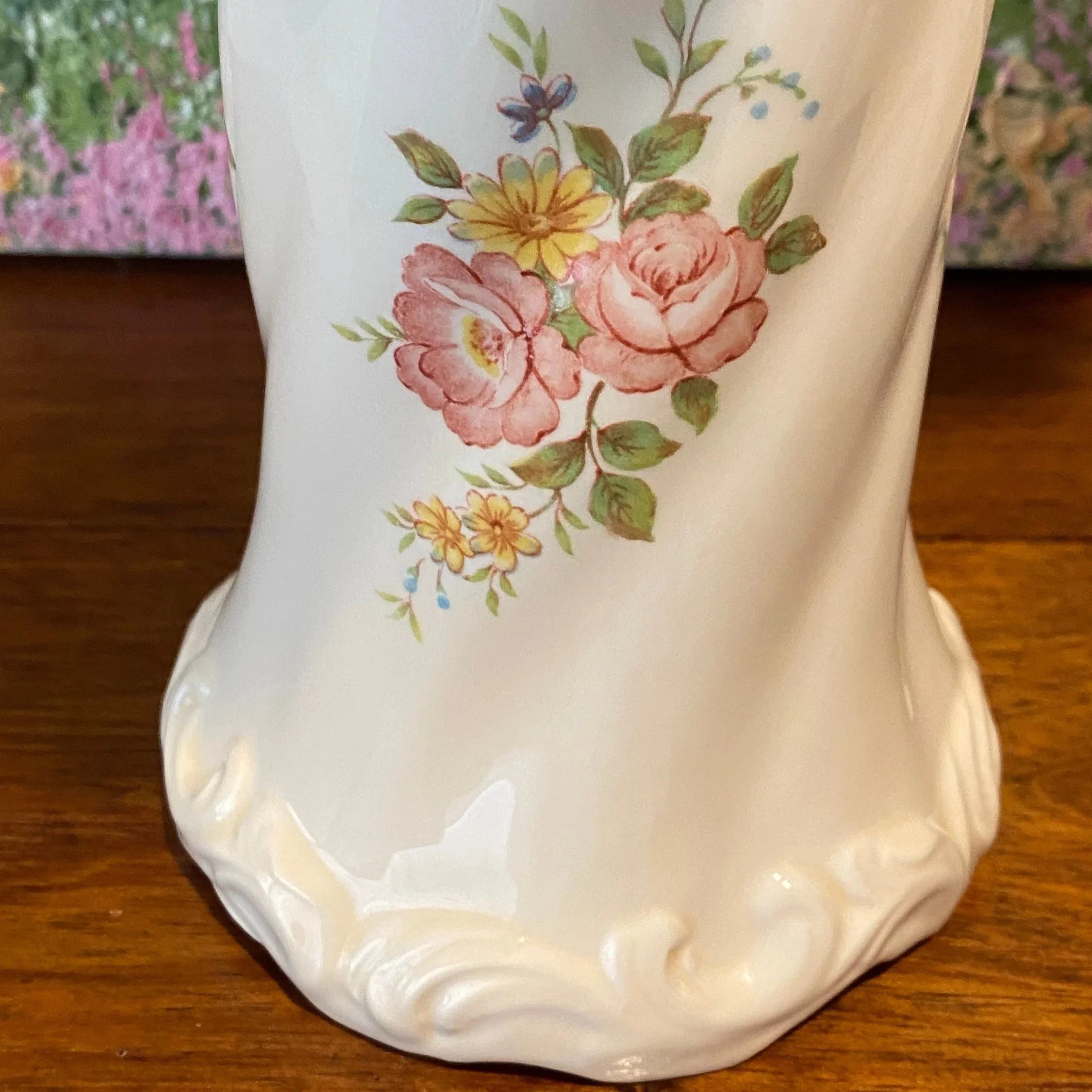 Full height view of twisted porcelain vase with floral decoration