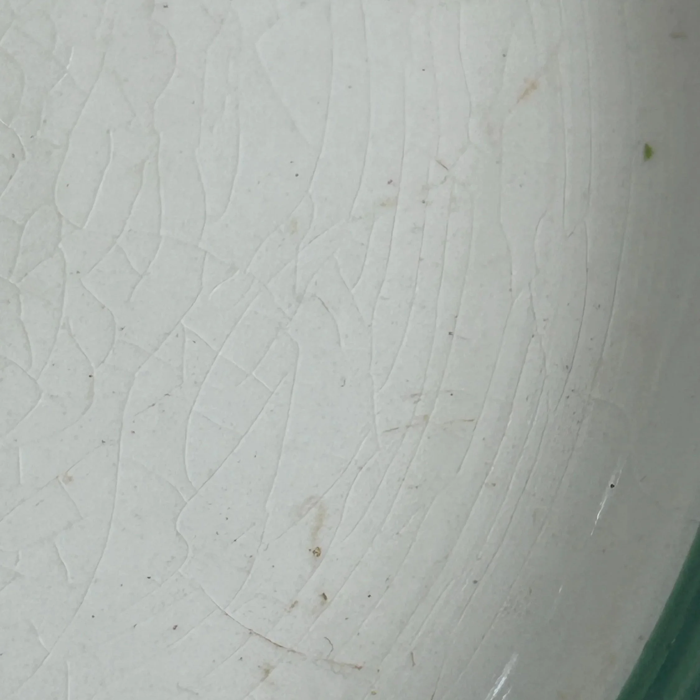 Close-up of the crazing on the cream glaze surface near the rim