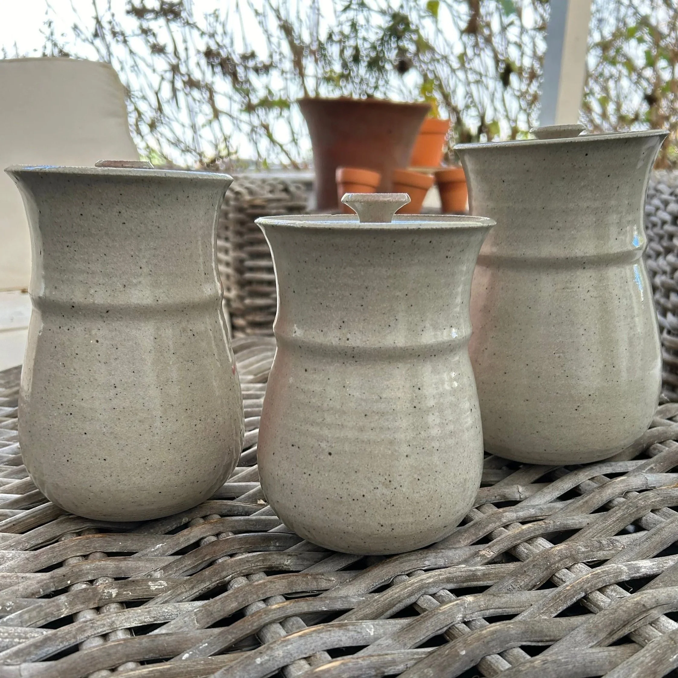 Outdoor view of the canisters from behind, showcasing their smooth glaze