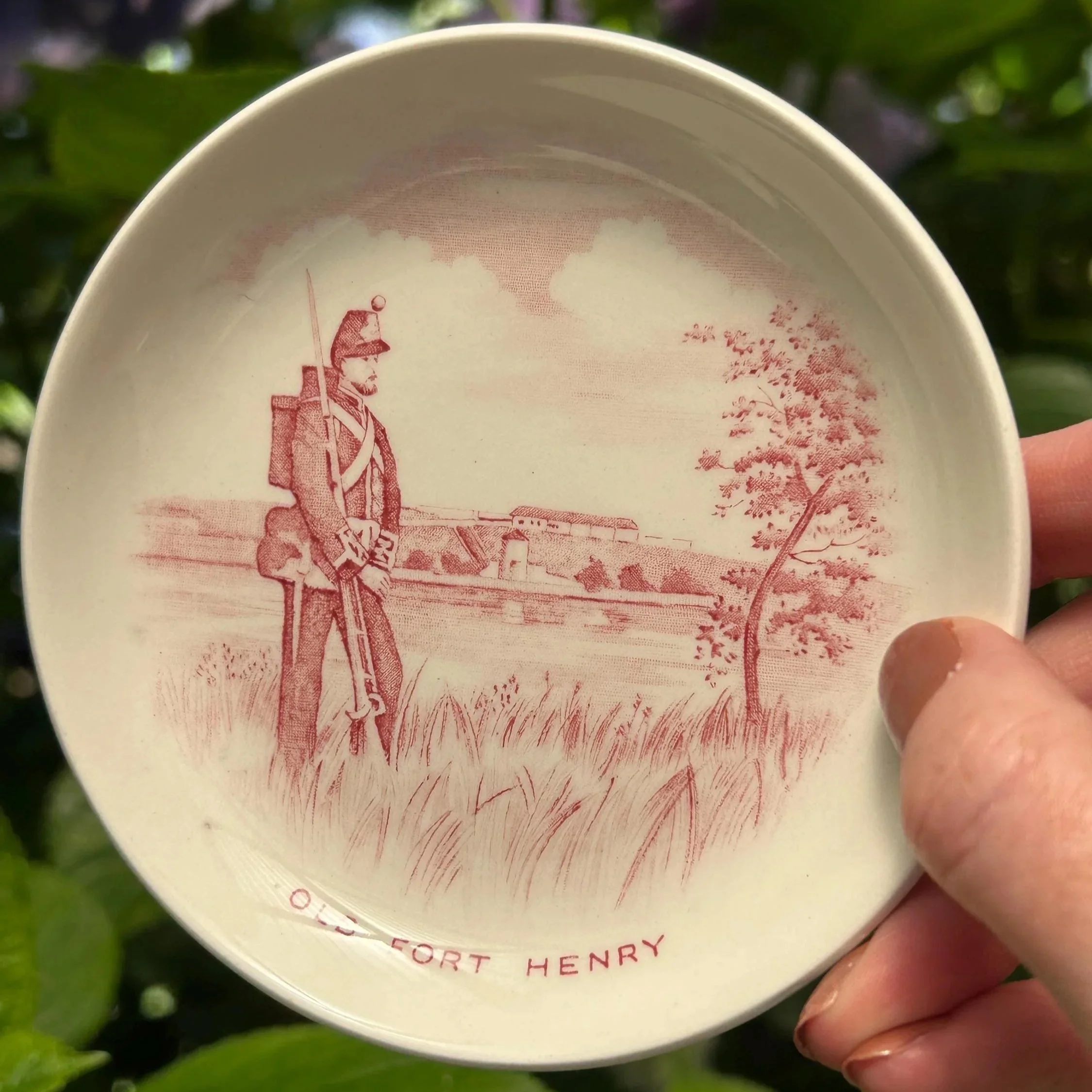 Front view of ring dish showing full red transferware scene of soldier and Fort Henry