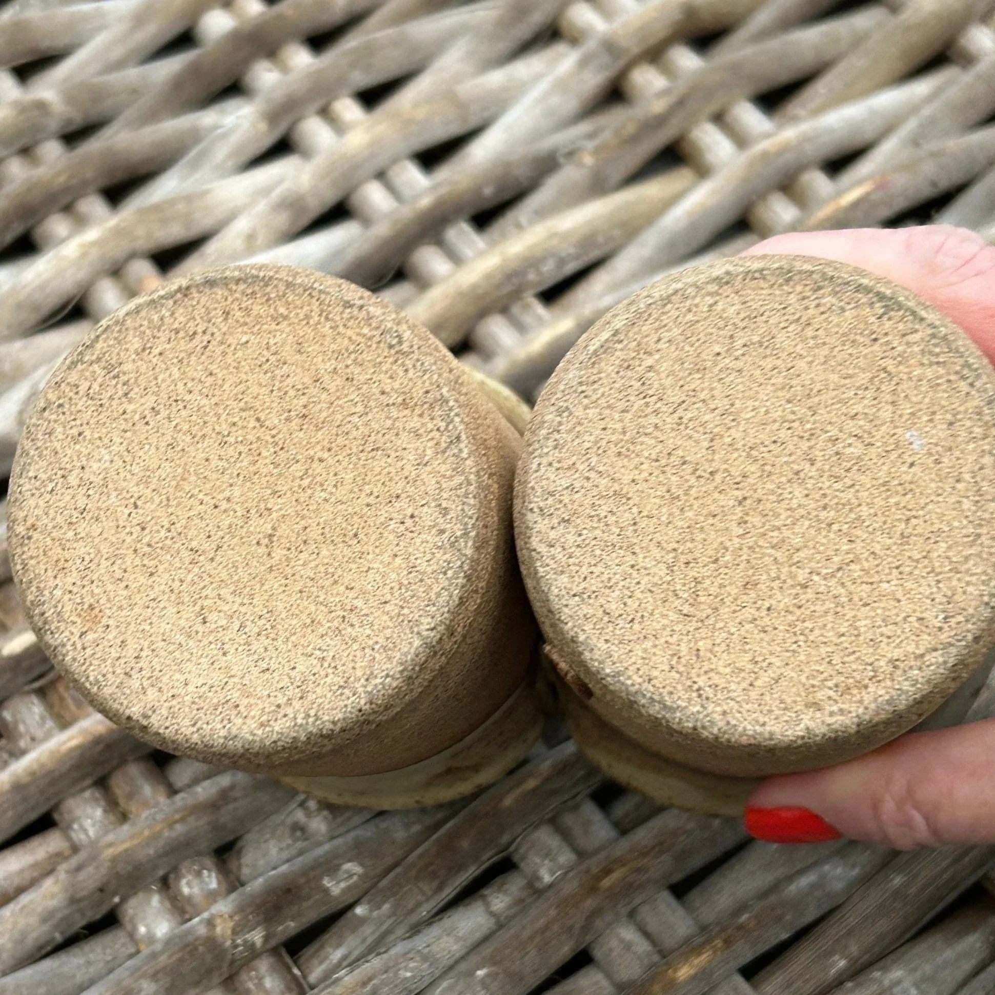 Bottoms of each cup showing unglazed base and textured clay